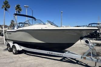2022 Key West 239 DFS boat on trailer, parked outdoors under clear blue sky.