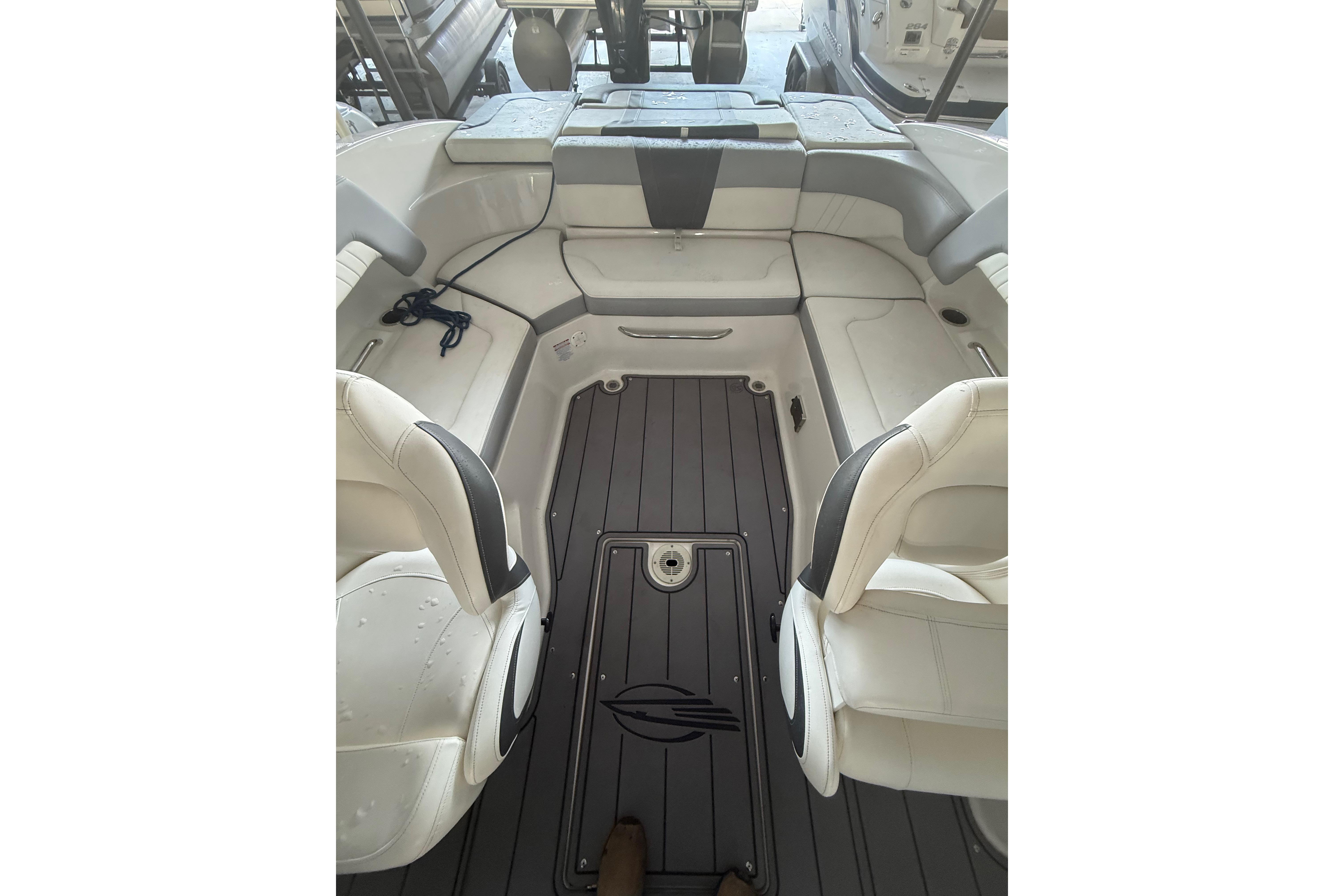 2023 Chaparral 230 SSi boat interior with white seating and gray flooring.