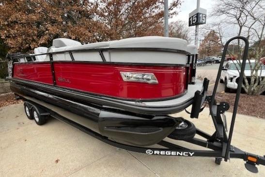2023 Regency 230 LE3 Sport pontoon boat on trailer, red and black design.