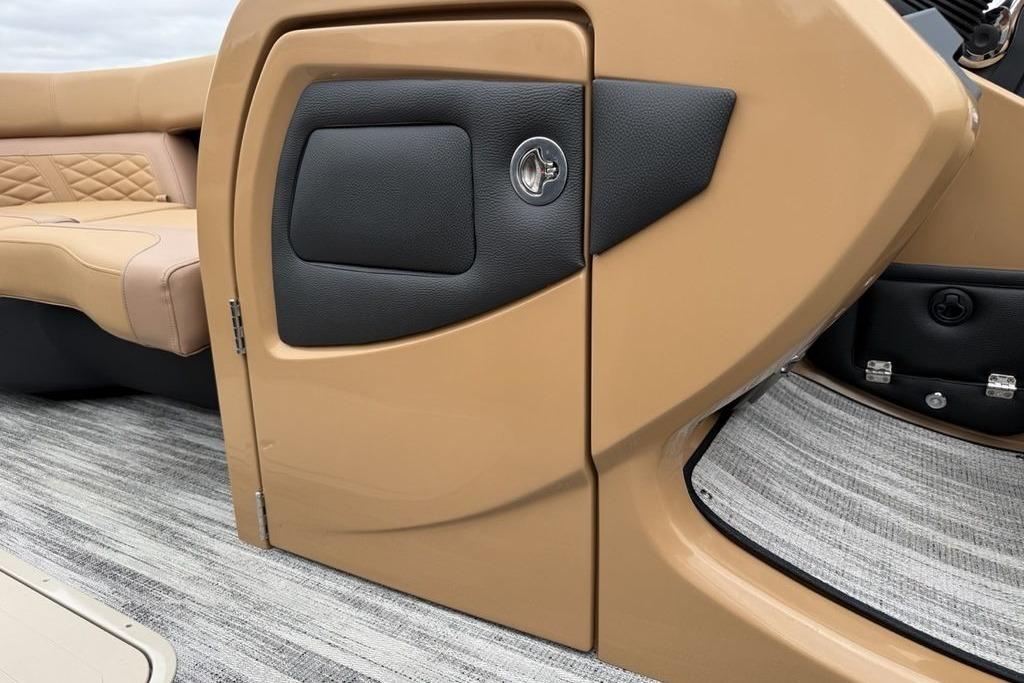 2026 Godfrey Monaco 235 SFLC iMPACT boat interior with tan seating and sleek design.