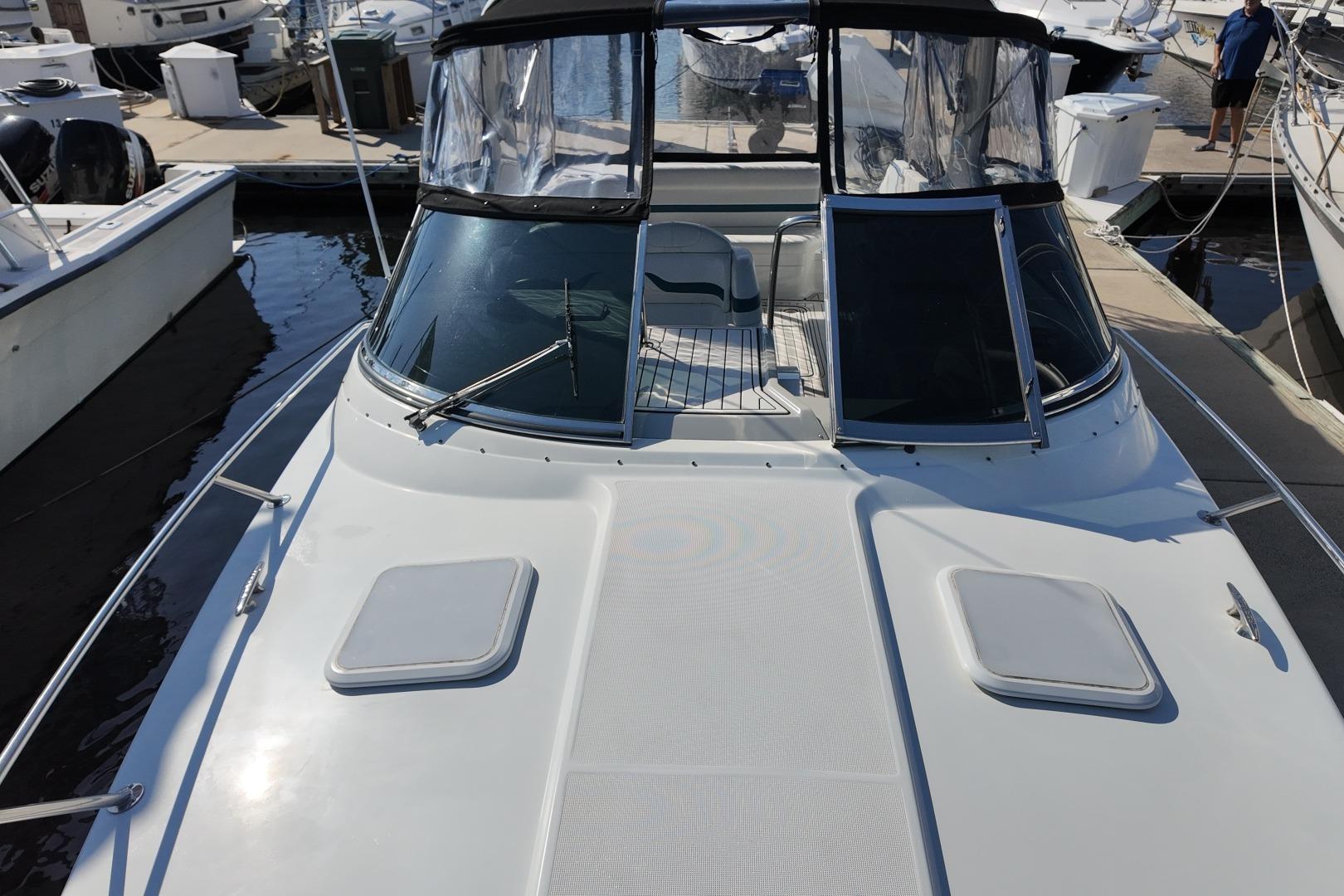 2007 Formula 330 Sun Sport boat docked at marina, featuring sleek design and spacious deck.