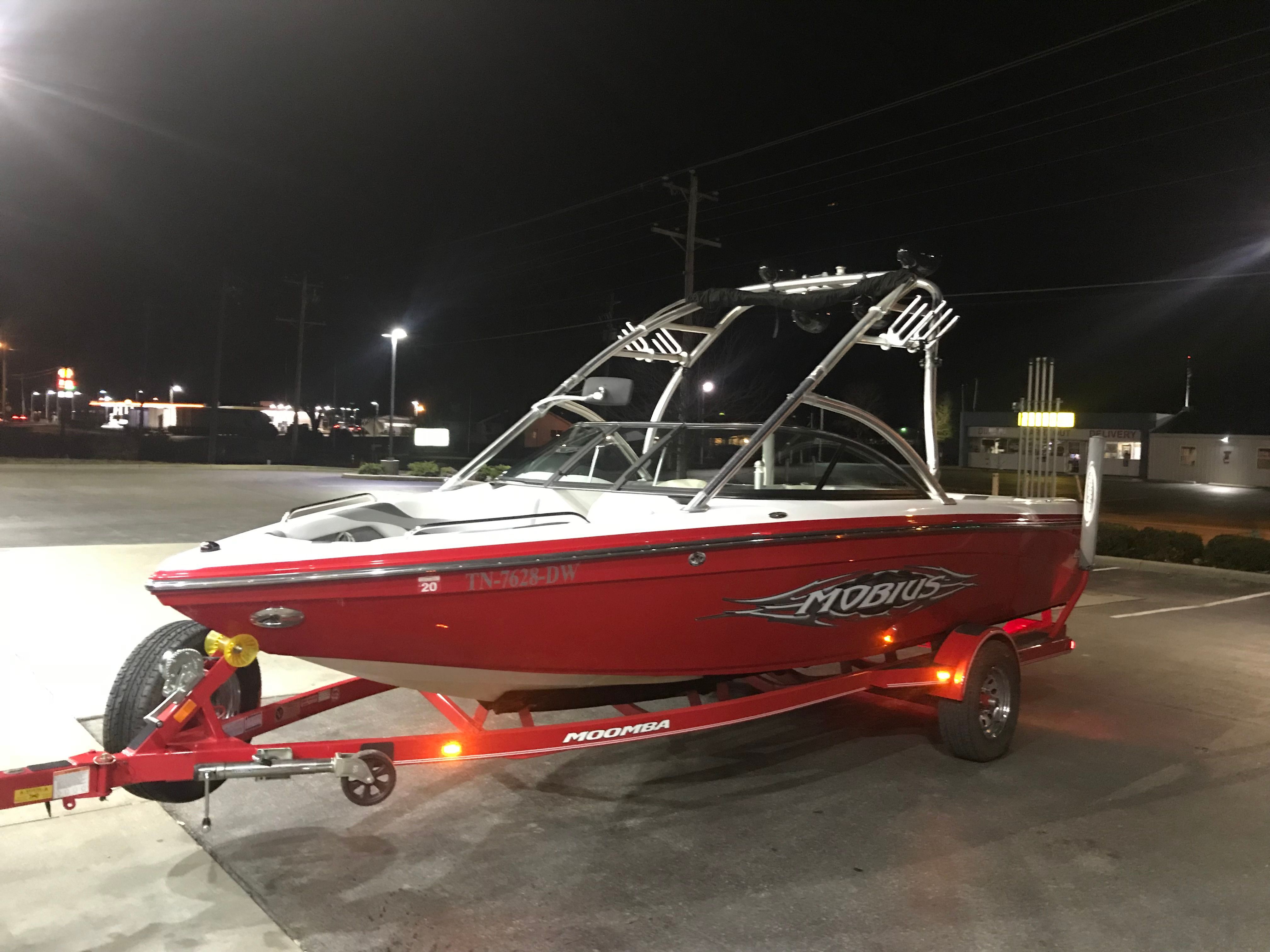 2008 Moomba Mobius LS boat on trailer at night.