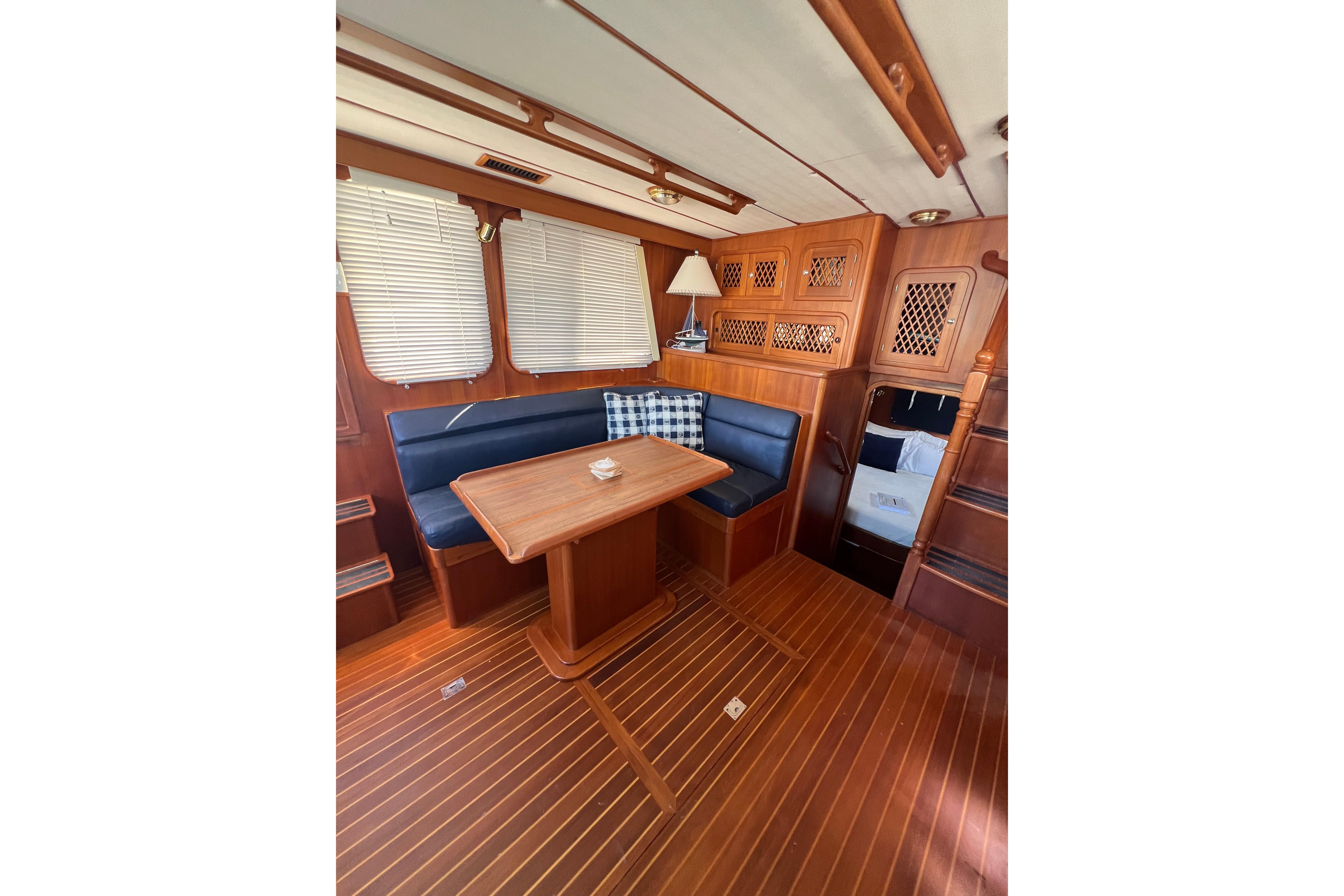 Interior of 2007 Heritage East 36 Sundeck Trawler with wooden furnishings and seating area.