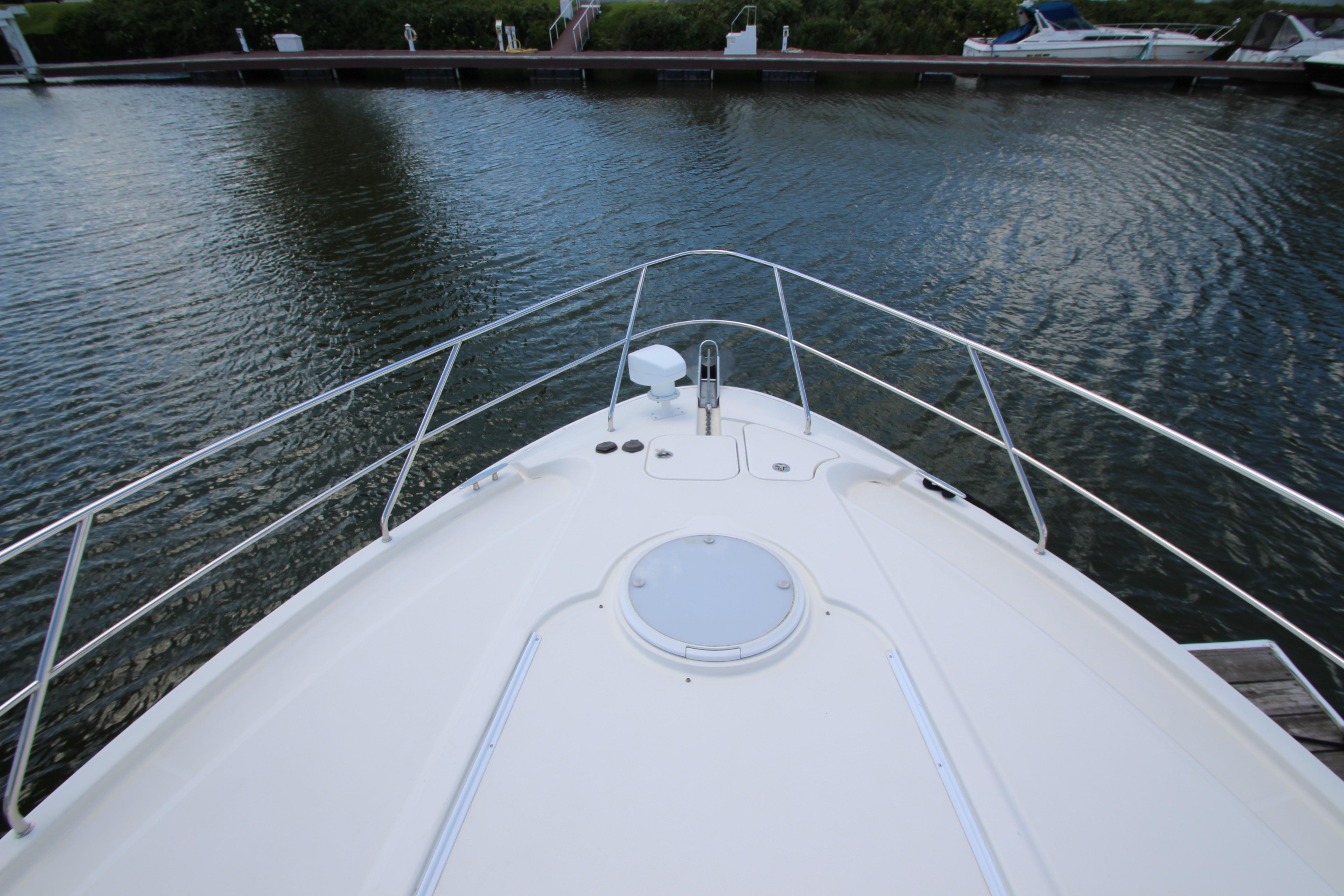 Bow view of 2006 Silverton 38 Sport Bridge at a marina dock.