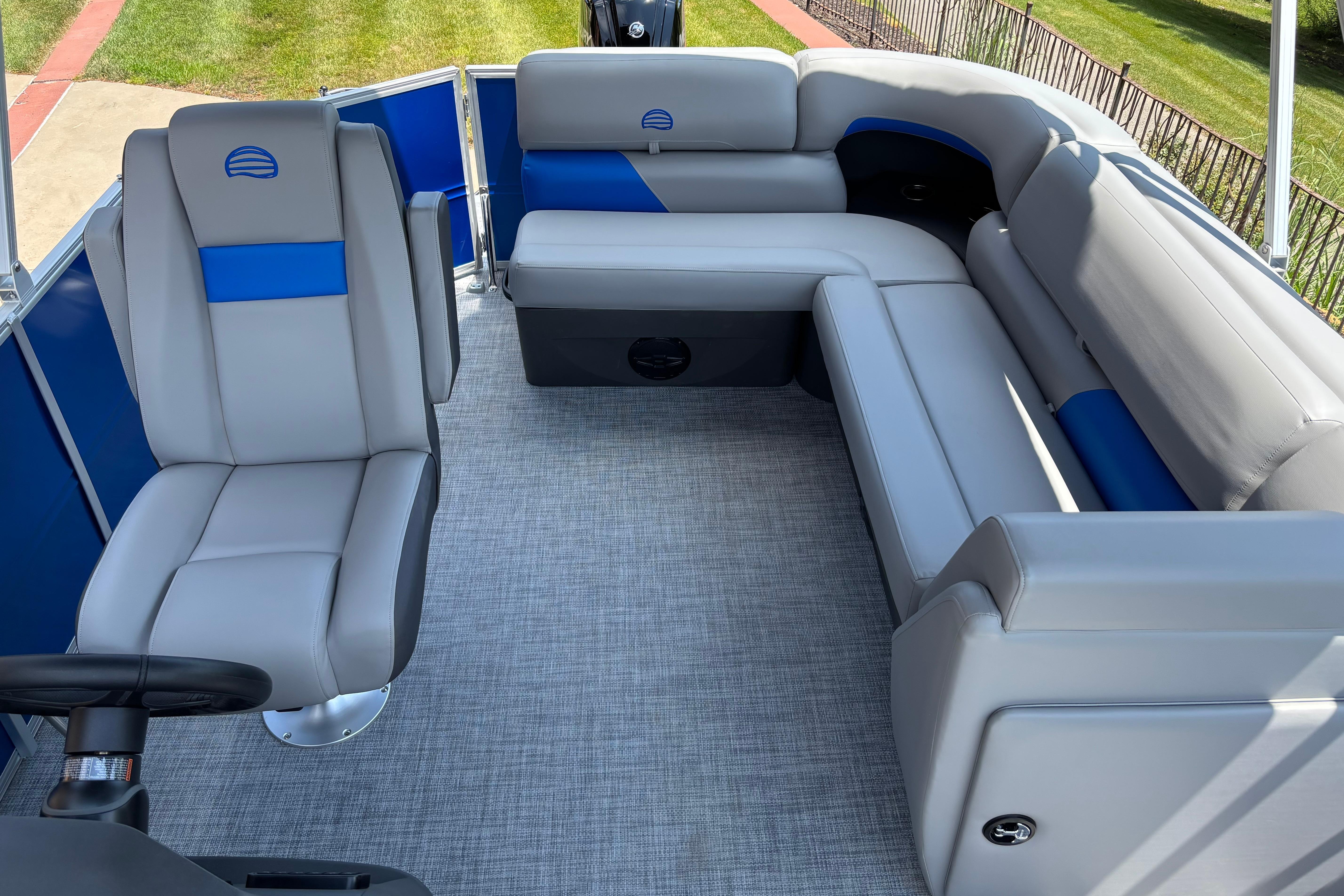 2026 Sun Tracker Party Barge 20 DLX interior with gray and blue seating, spacious layout.