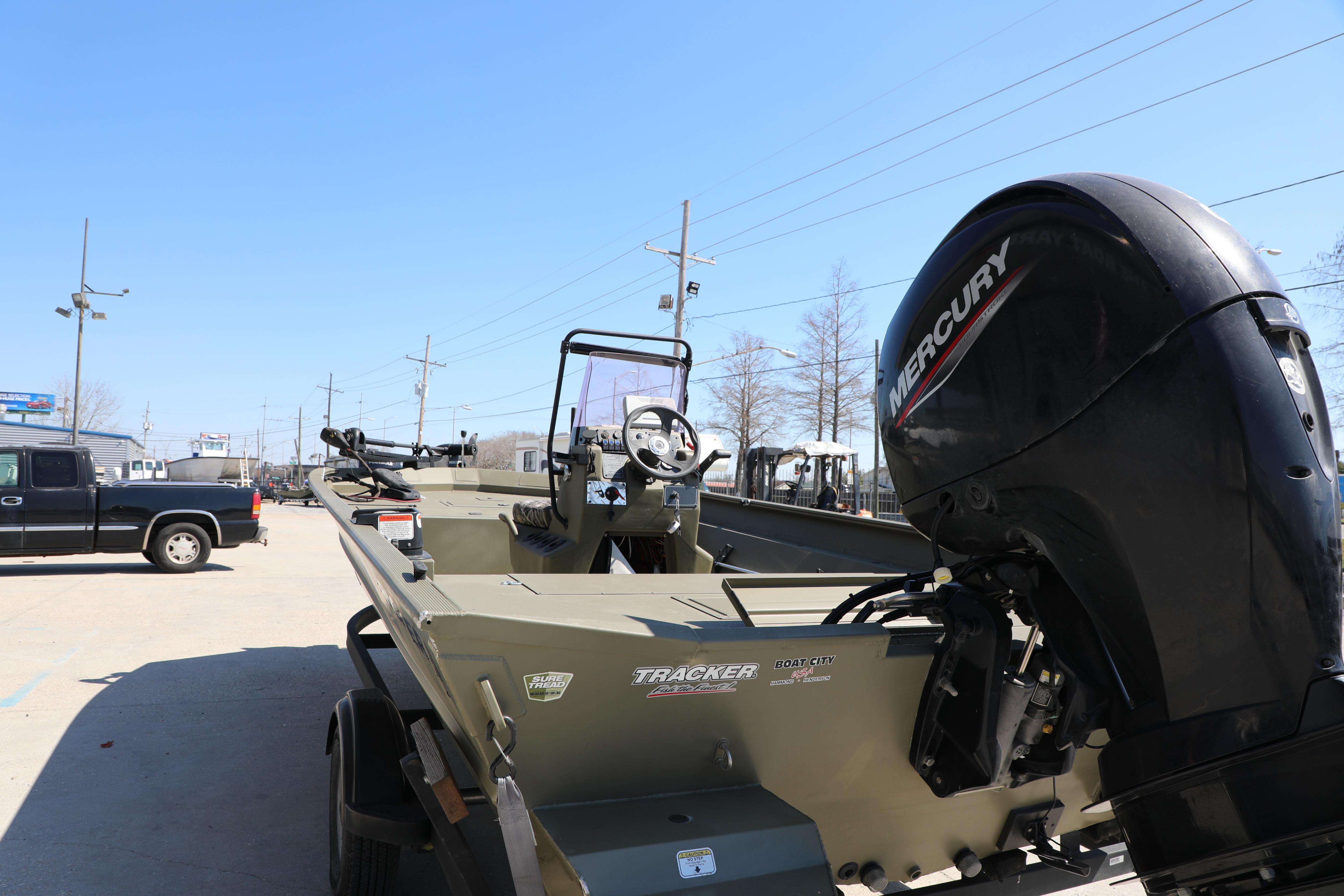 2021 Tracker Grizzly 2072 SC boat with Mercury engine in outdoor setting.