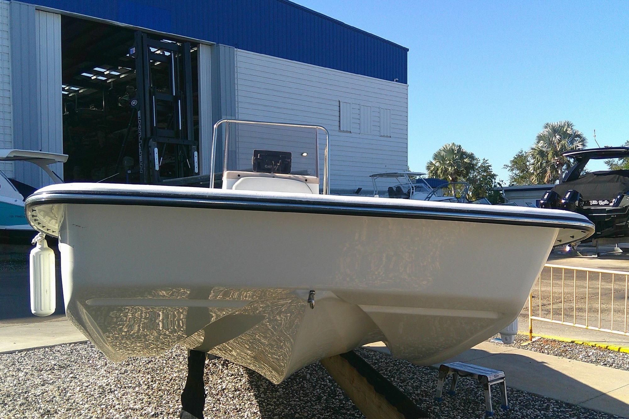 2017 Outcast 19V boat displayed outdoors near a storage facility.