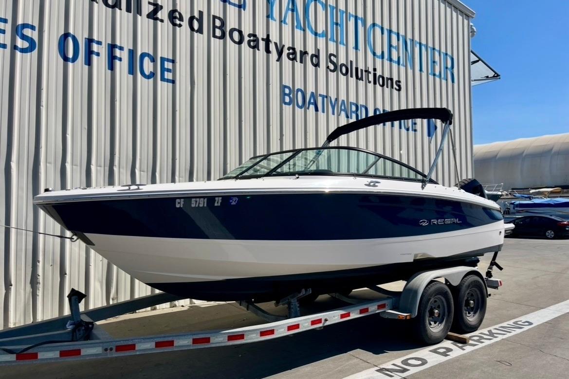 2025 Regal LX2 boat on trailer at yacht center, sunny day.