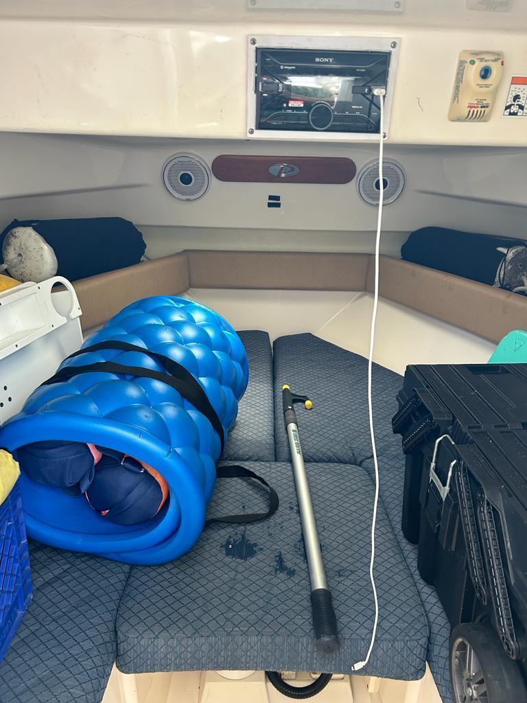 Interior of a 2012 Pursuit 255 boat with gear and equipment.