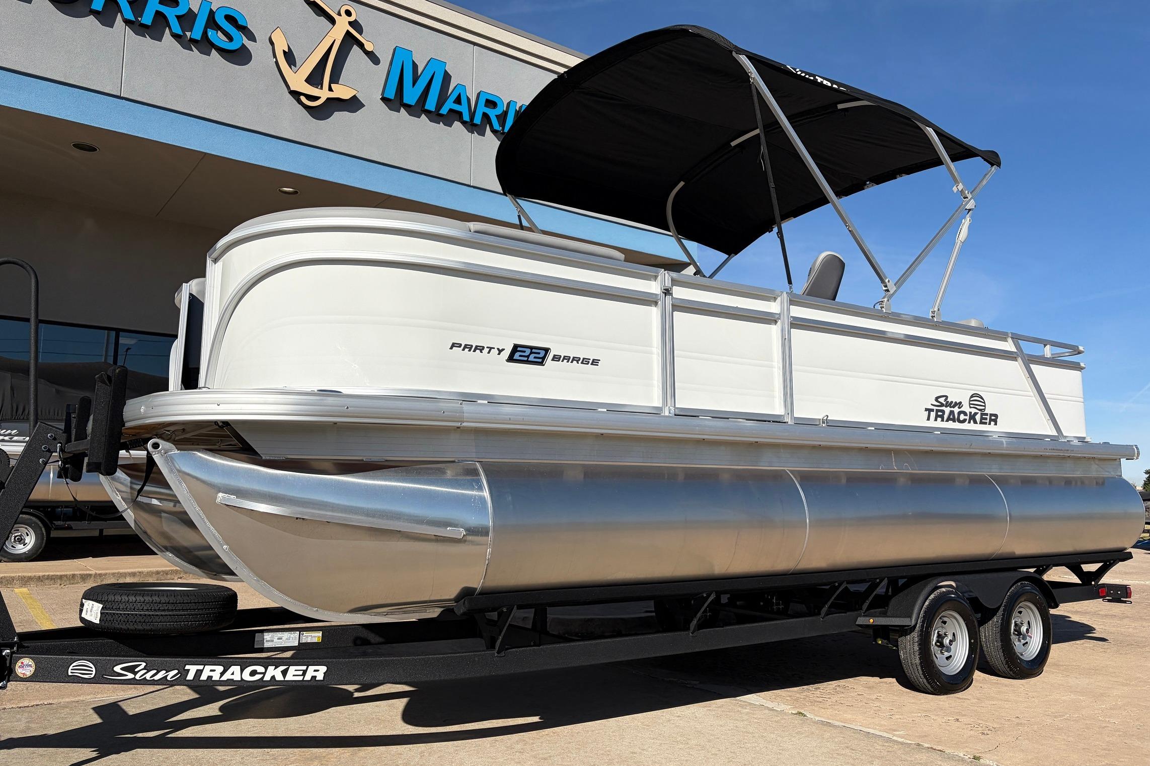 2026 Sun Tracker Party Barge 22 RF XP3 pontoon boat on trailer at dealership.