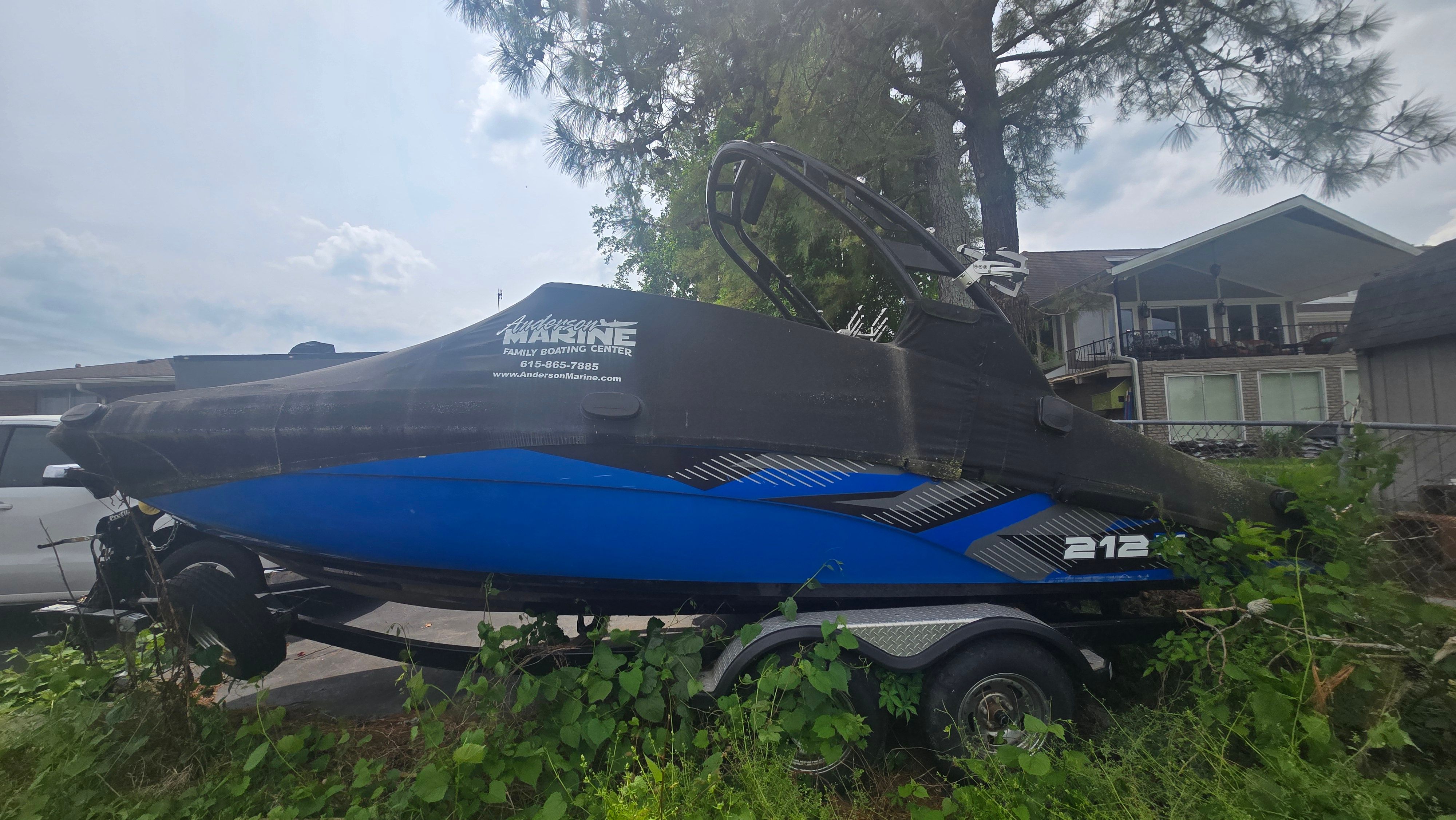 2017 Yamaha Boats 212X on trailer, covered, parked outdoors.