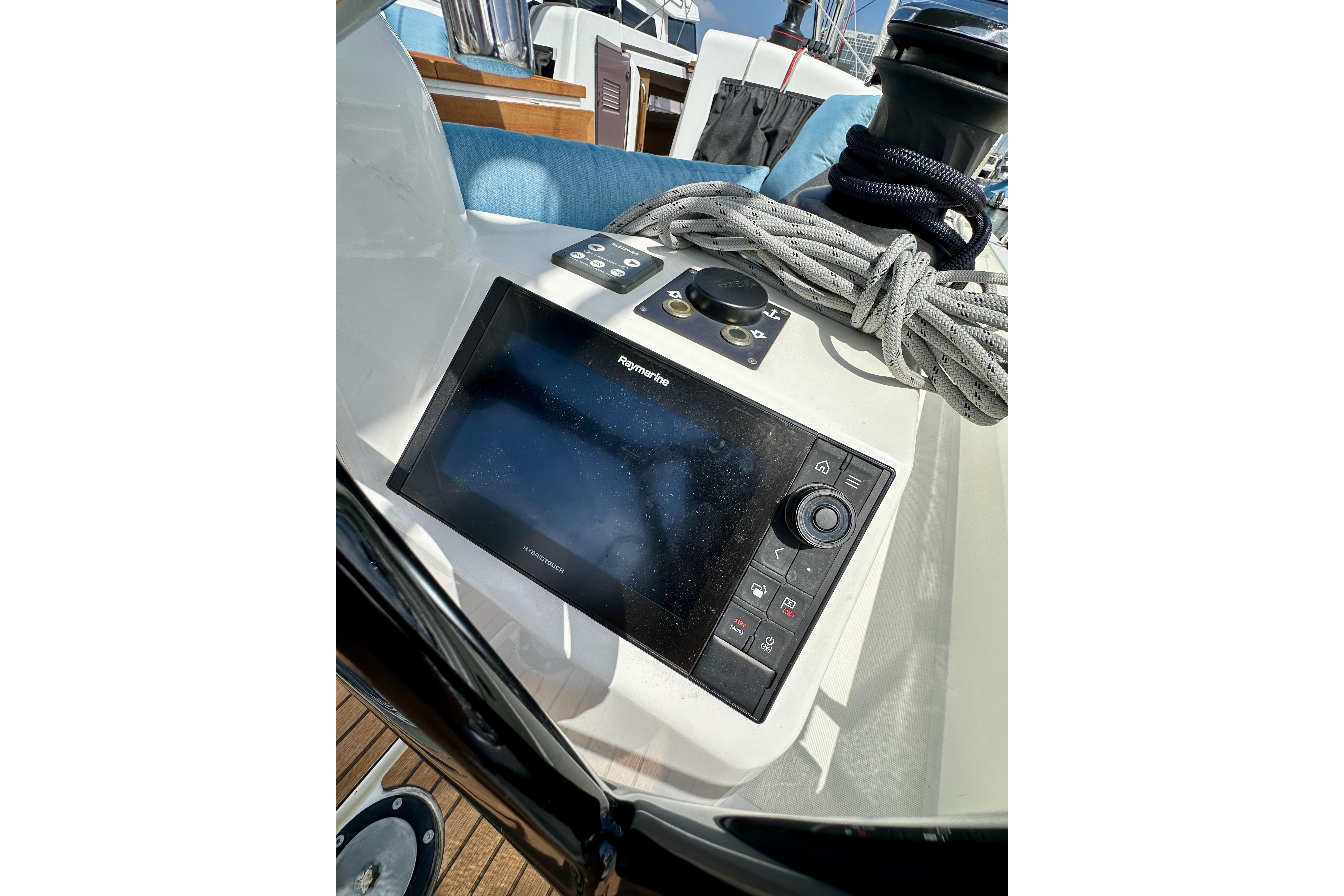 2024 Jeanneau Sun Odyssey 410 cockpit with navigation display and coiled ropes.