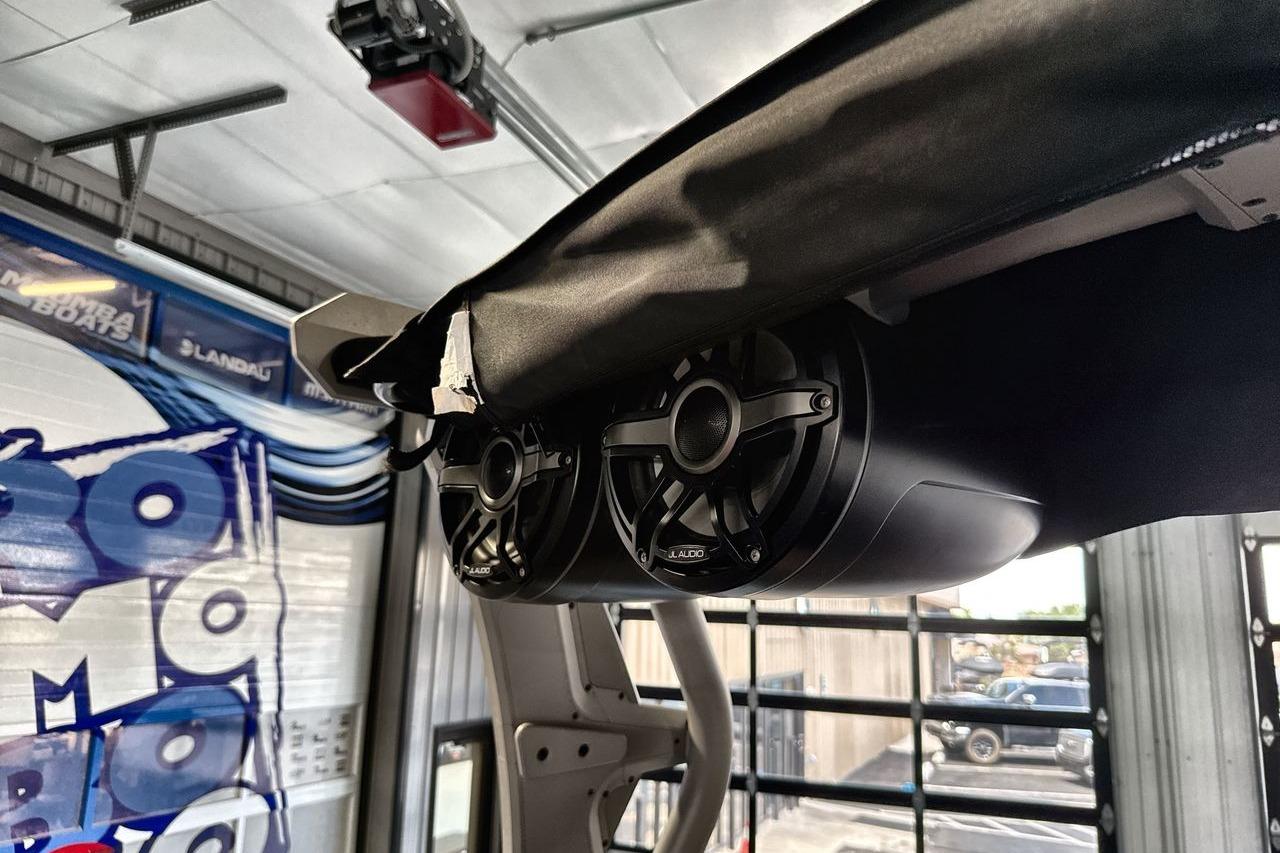 Speakers installed on a 2021 Supra SE 550 boat, inside a garage setting.
