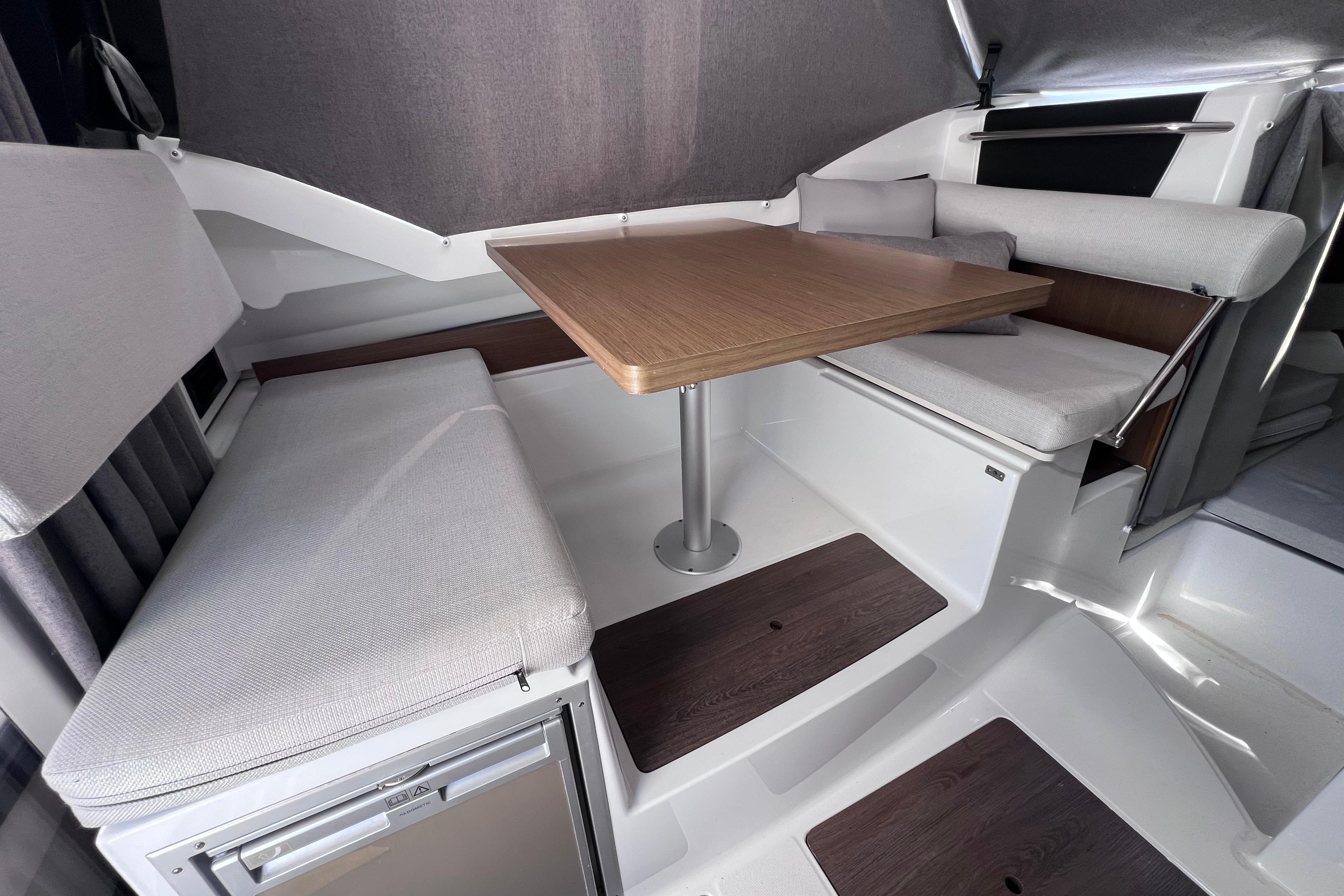 Interior of 2021 Jeanneau NC Weekender 795 Series 2 with seating and table.