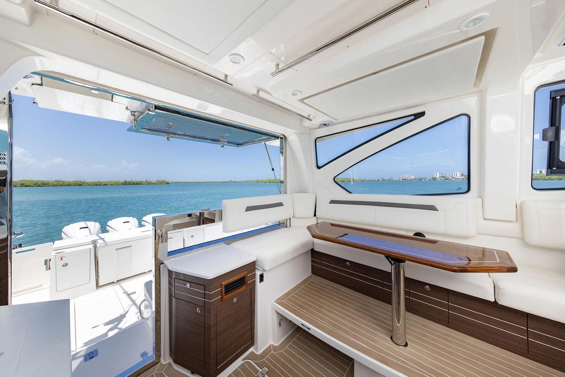 Manufacturer Provided Image: 2025 Pursuit OS 445 Offshore yacht interior with elegant seating and ocean view.