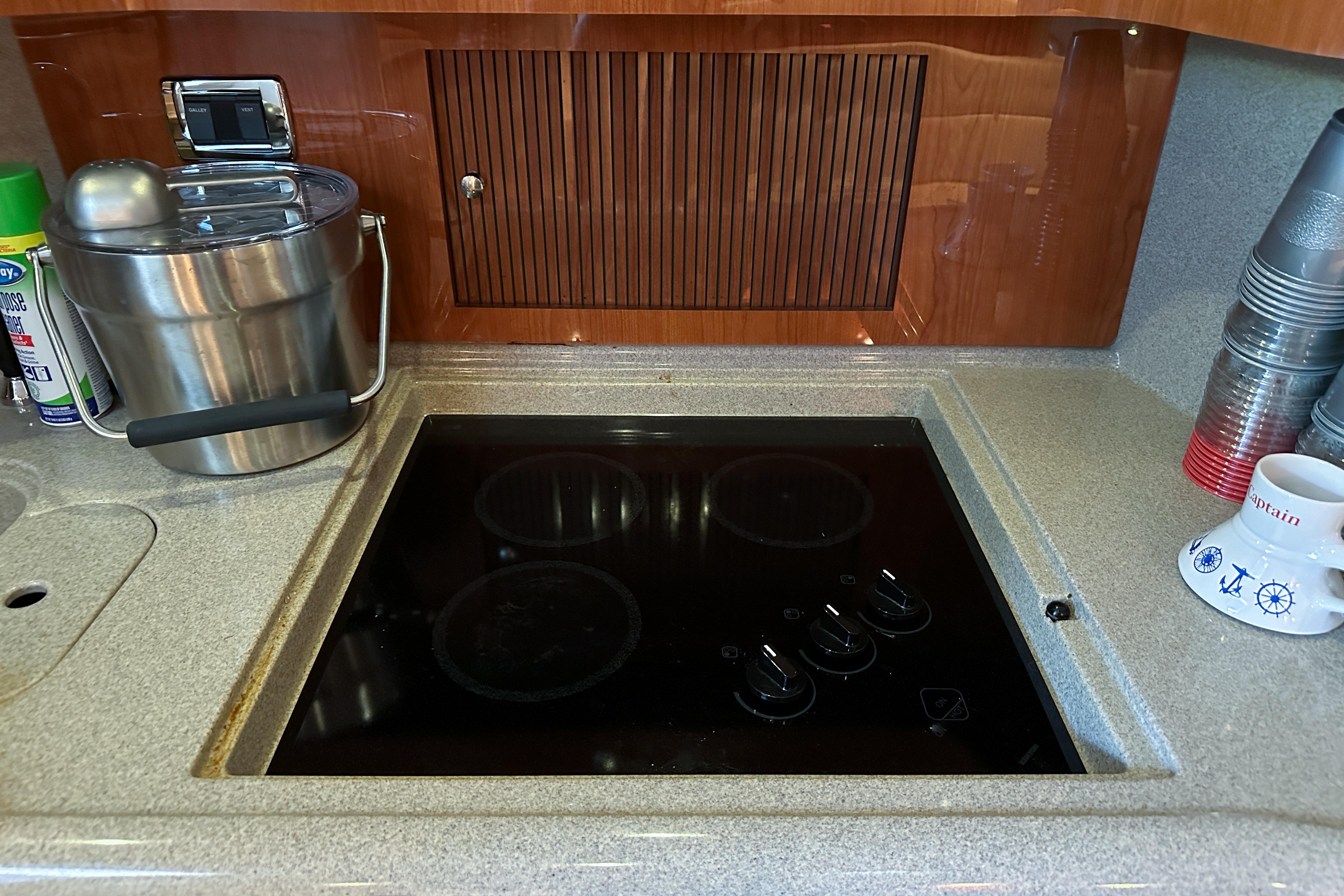 Galley kitchen in 2001 Sea Ray 410 Sundancer with stovetop and countertop accessories.