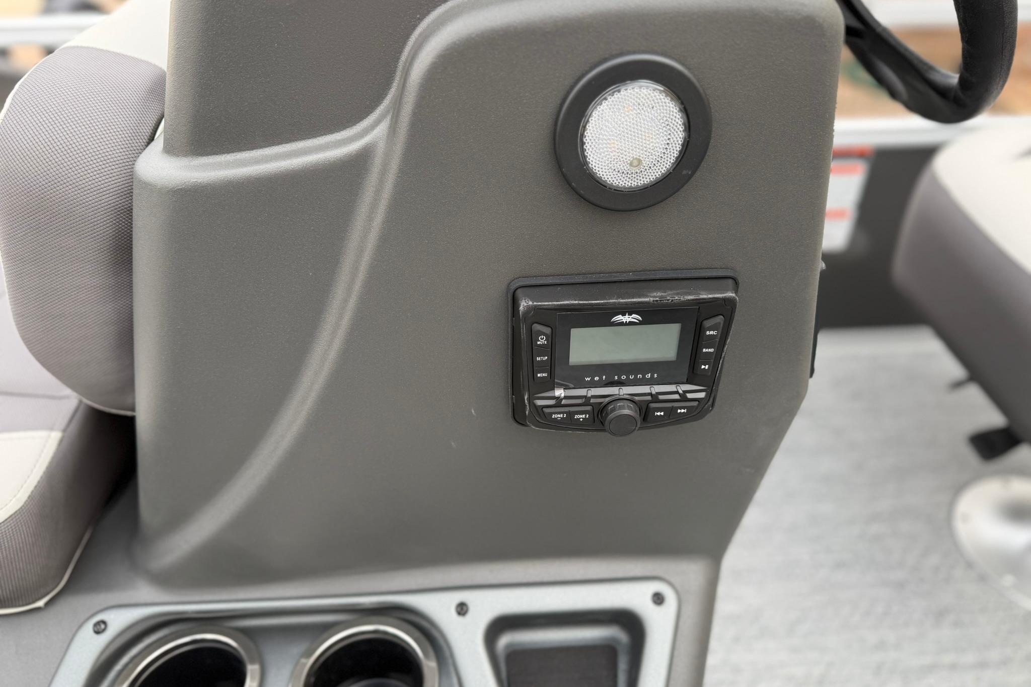 2026 Sun Tracker Bass Buggy 16 XL Select dashboard with audio controls and speaker.
