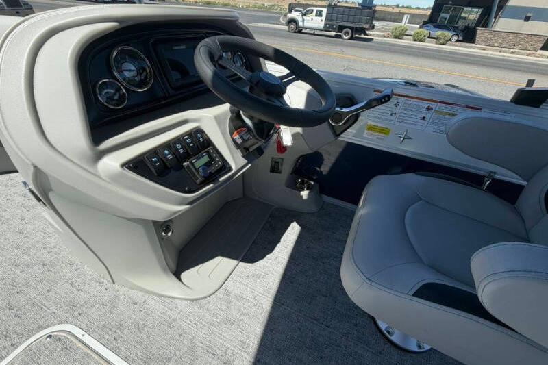 Interior view of 2026 Berkshire LE 24' Ultra Lounger boat's helm with steering wheel and controls.