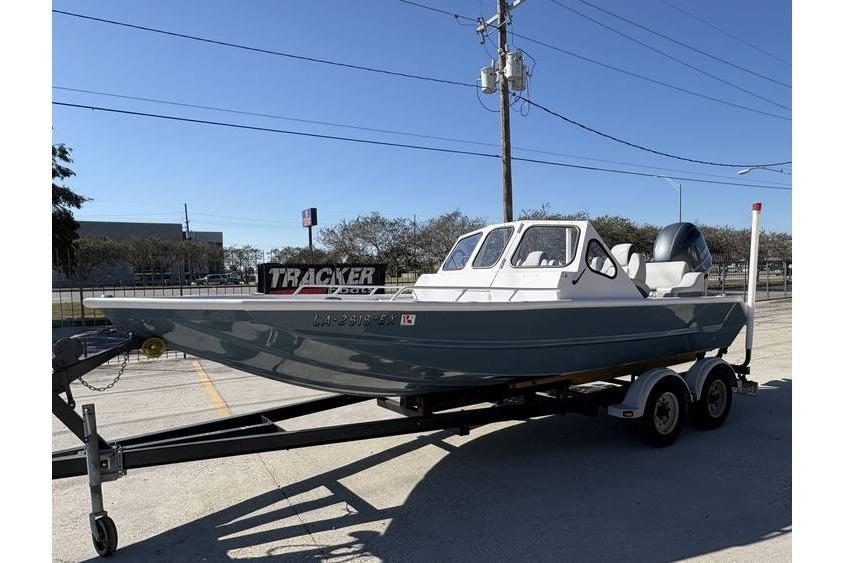 1997 Scully's 18 WT boat on trailer, parked outdoors under clear blue sky.