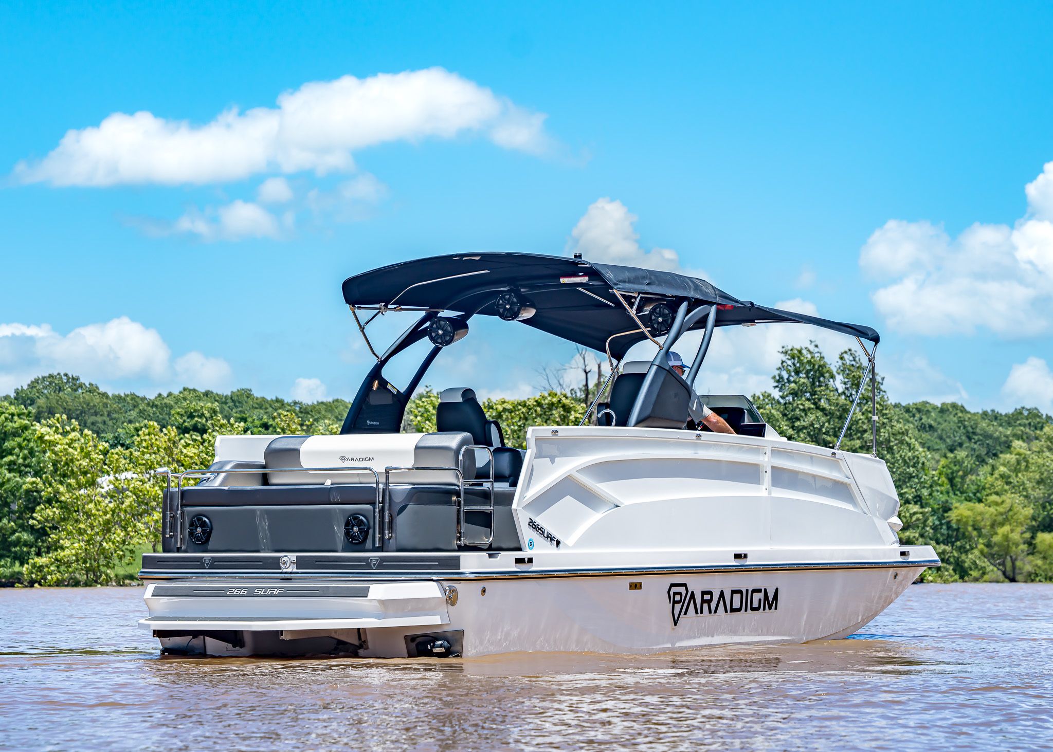 2025 Paradigm 266 SL SURF boat on calm water.