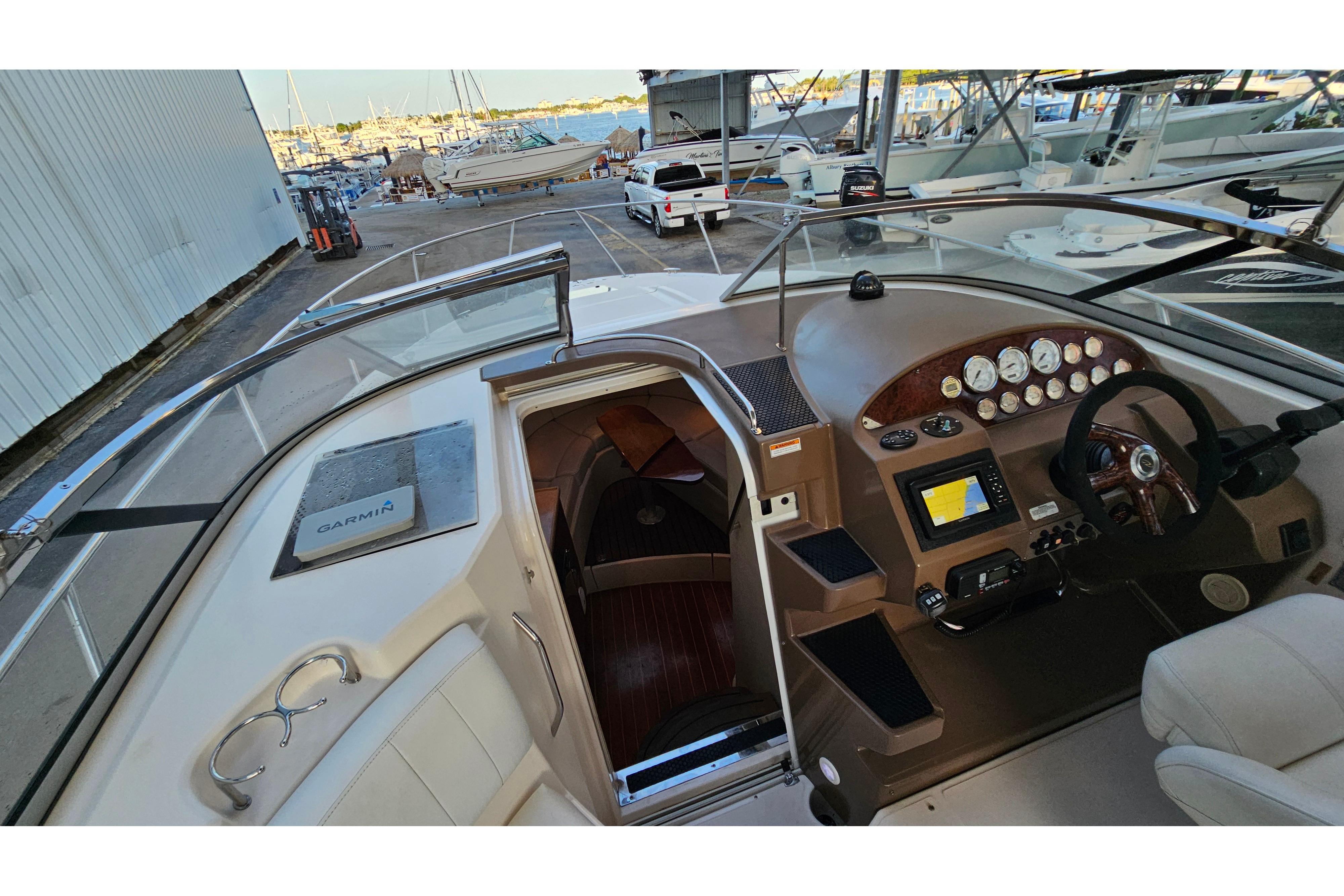 2005 Regal 3060 Window Express boat cockpit with navigation equipment and steering wheel.