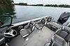 2023 Lund 1975 Tyee boat interior with seating, steering wheel, and lake view.