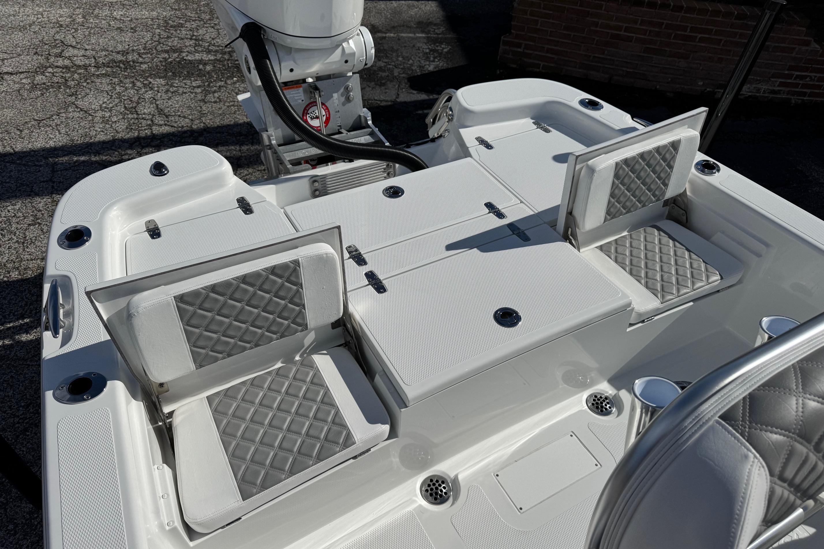 2026 BlackJack 256 Bay boat interior with foldable seats and storage compartments.