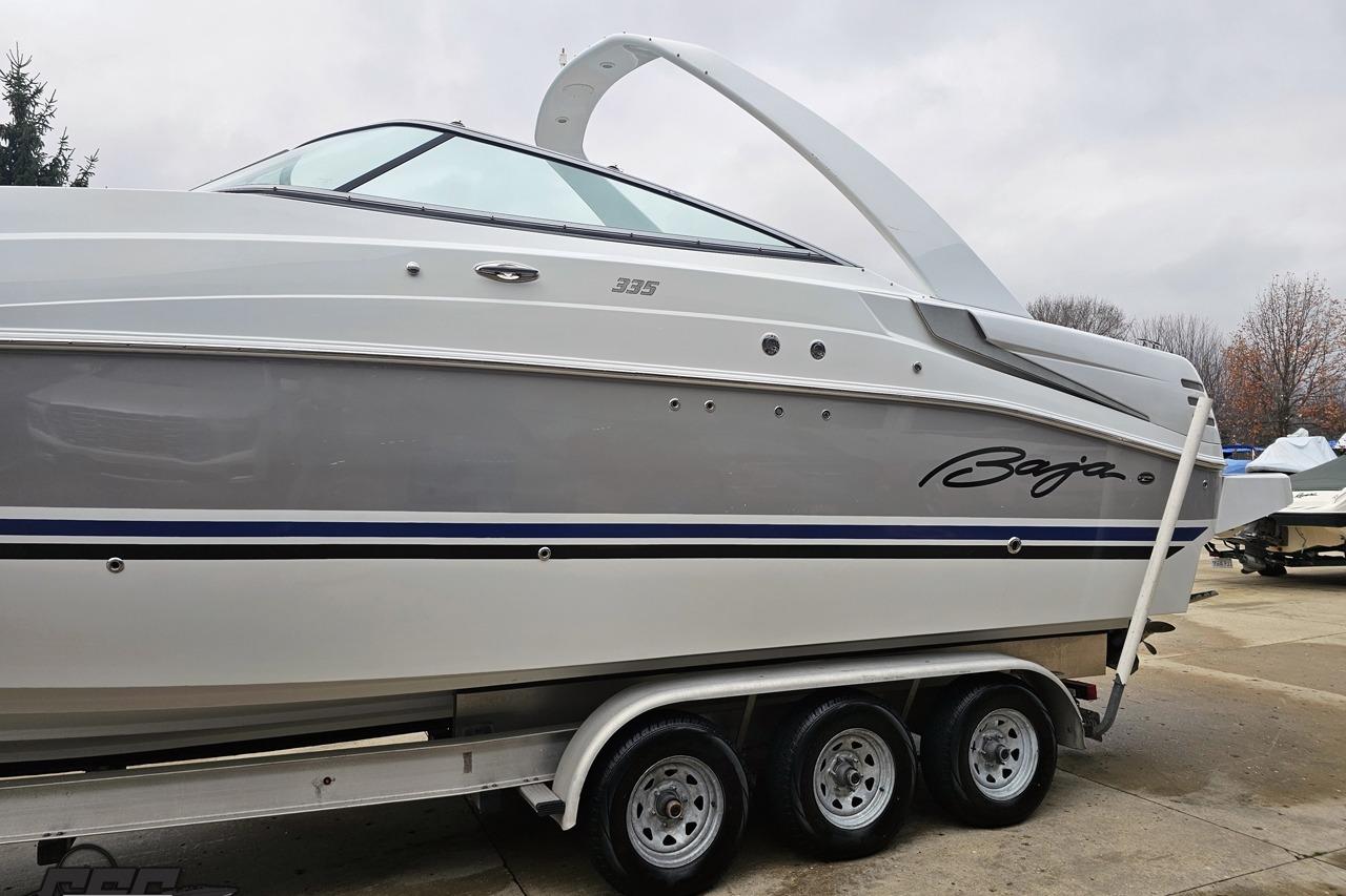 2008 Baja 335 Performance boat on trailer, side view with sleek design and branding.