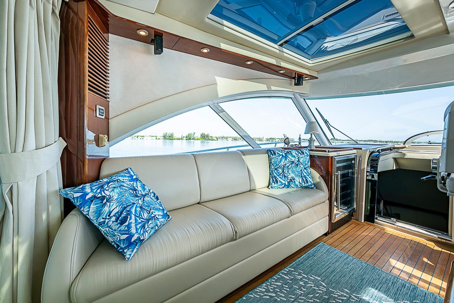 Luxurious interior of 2008 Sea Ray 60 Sundancer yacht with leather seating and blue accents.