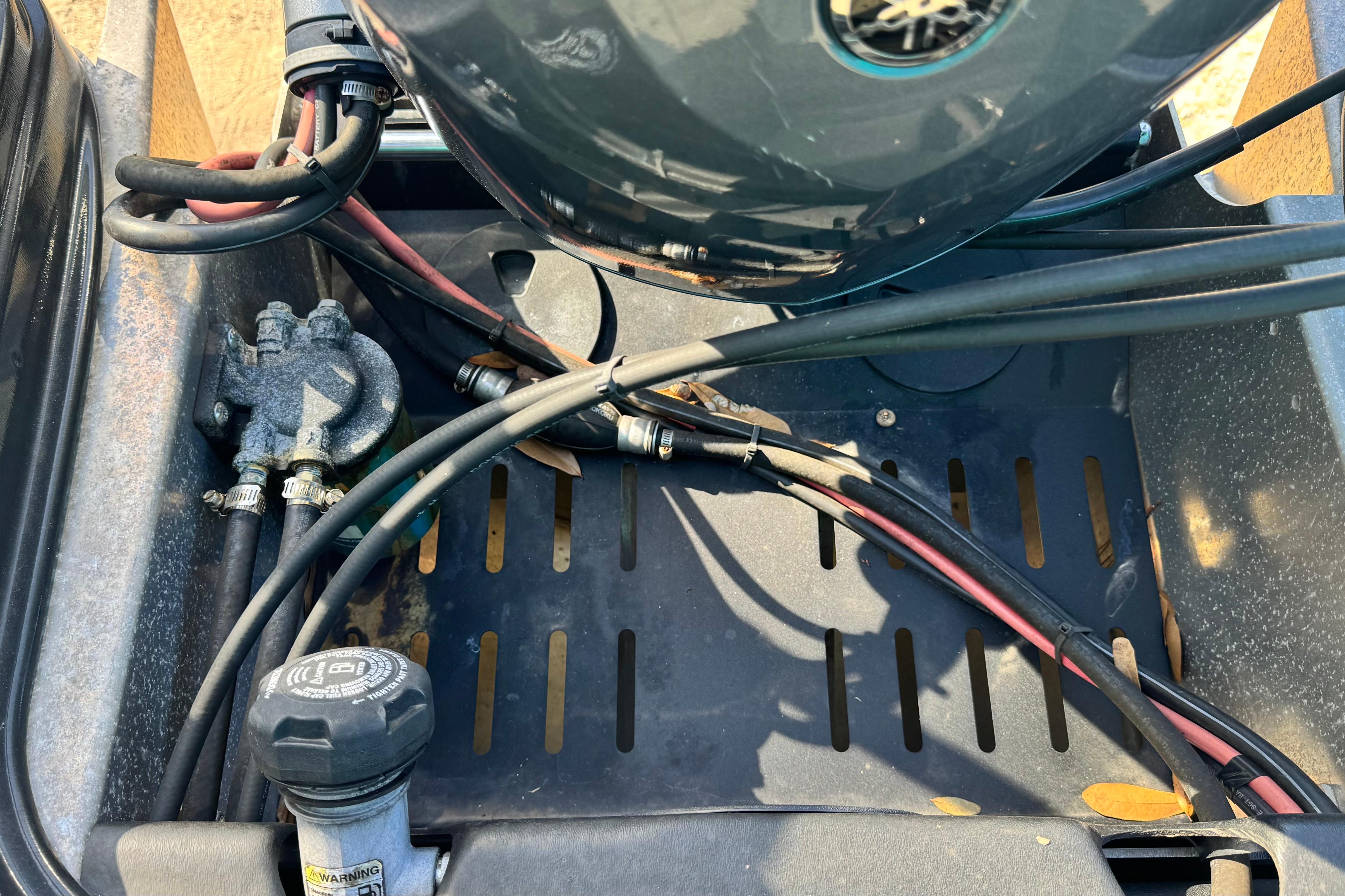 2023 Sylvan L5 CLZ boat engine compartment with cables and components.