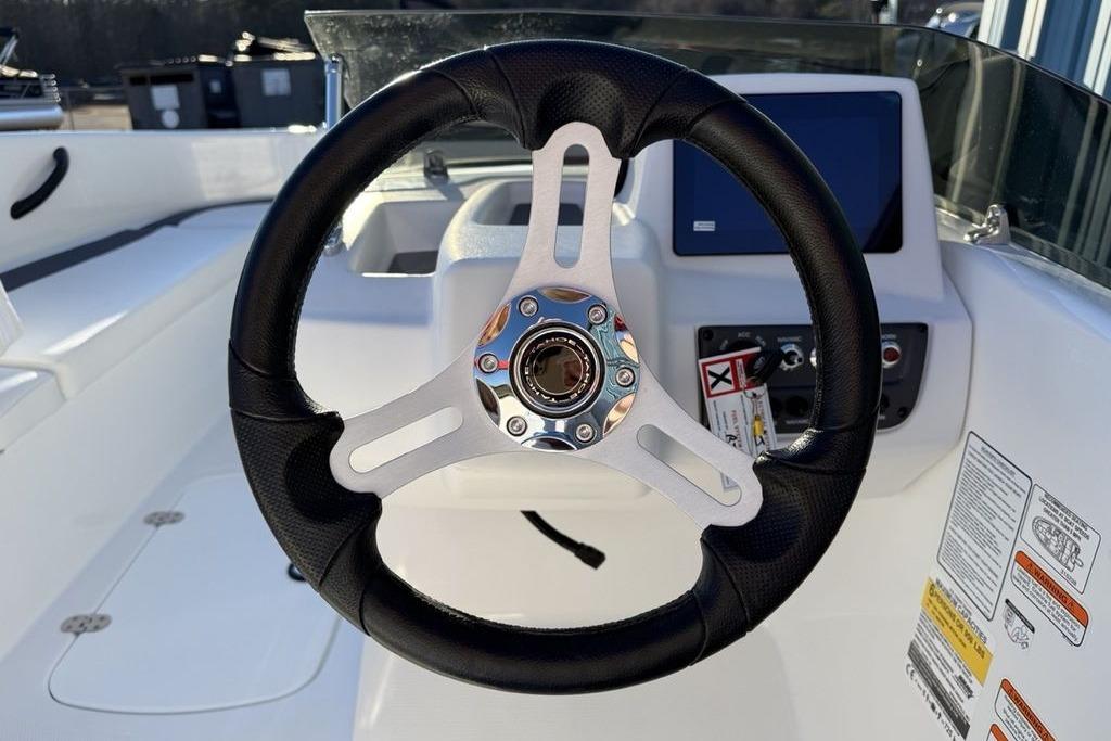 Steering wheel of 2026 Tahoe T16 boat with dashboard controls and display.