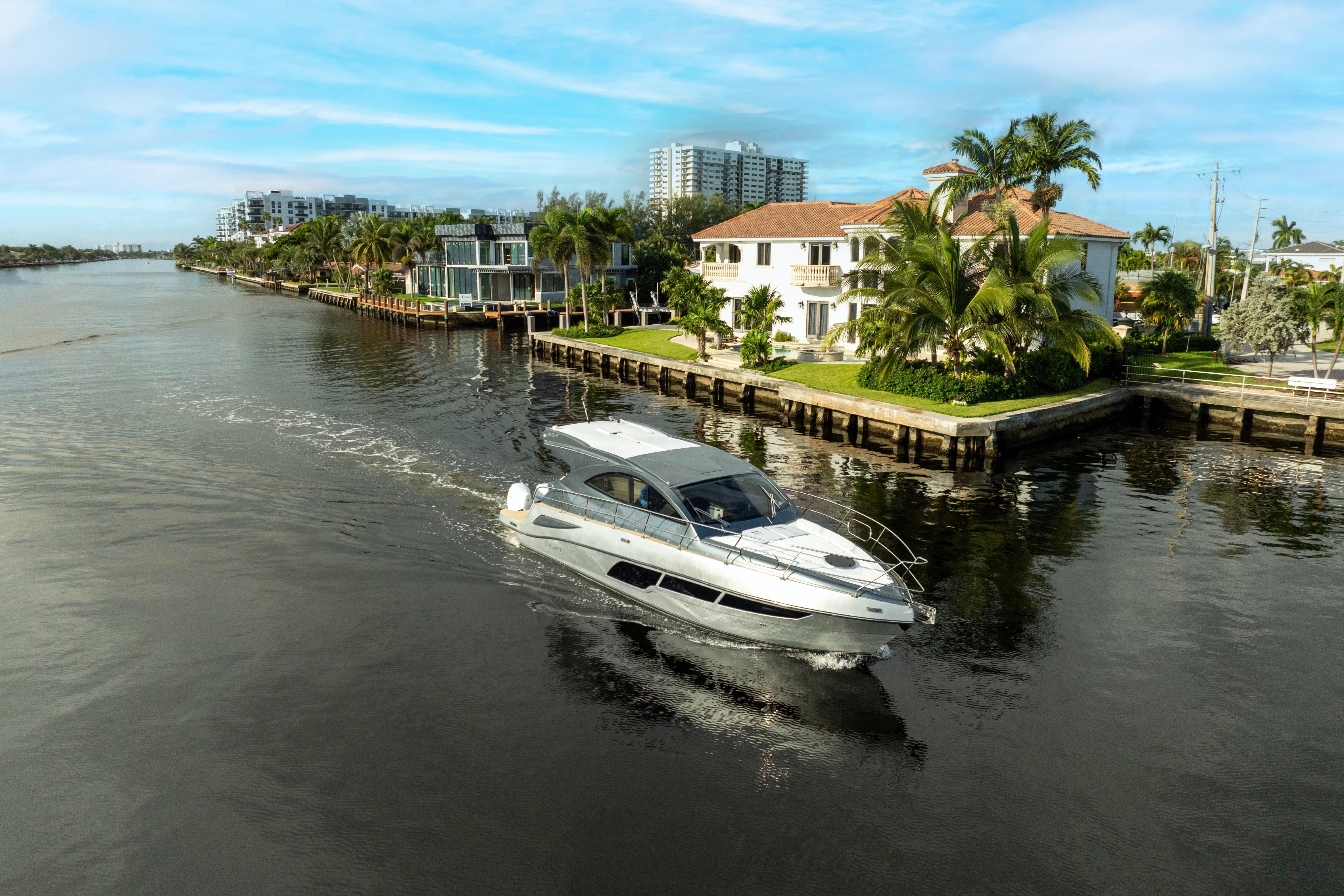 Luxury Valiatt 410HT yacht cruising near waterfront homes, 2025 model.