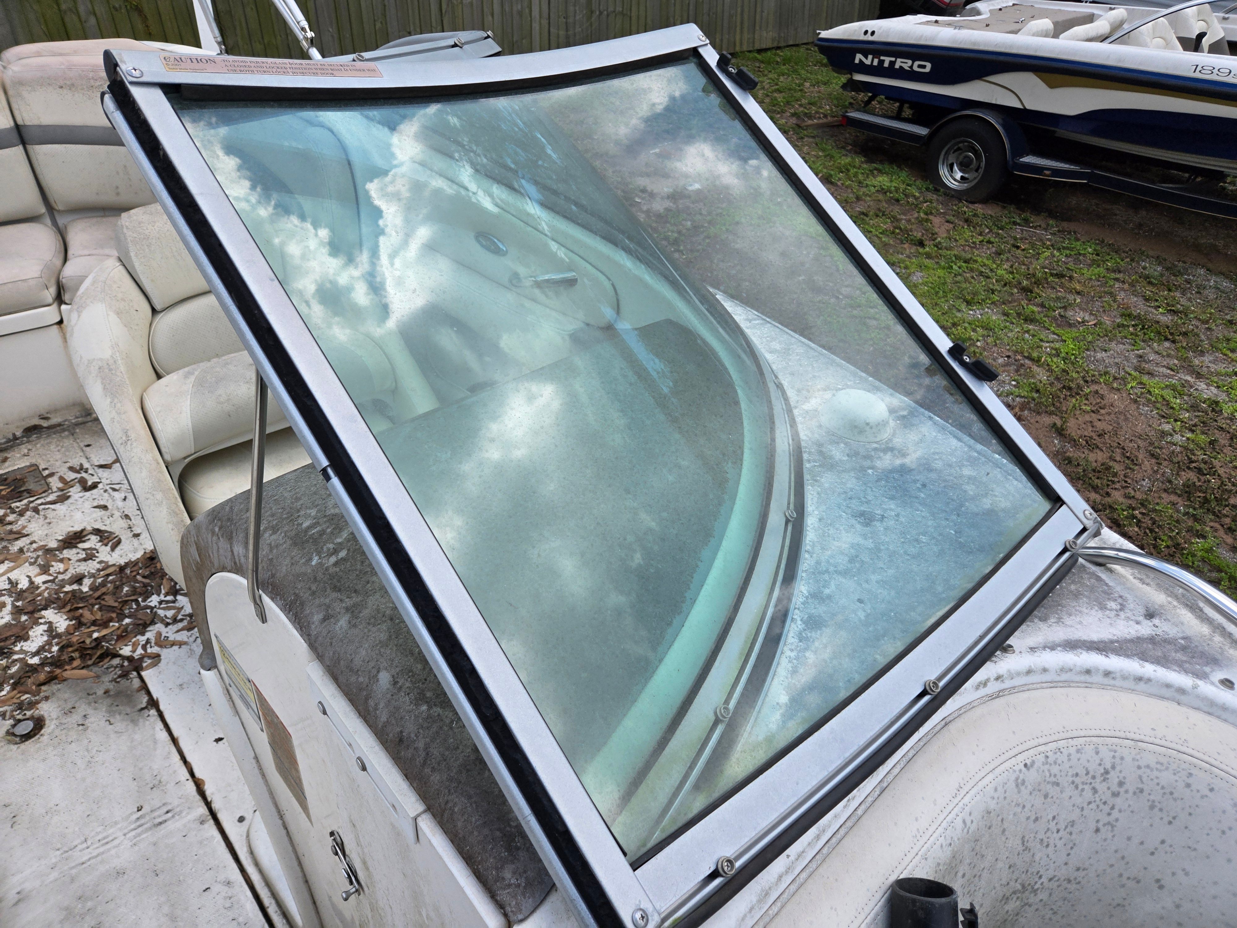 A 2006 Chaparral 220 SSi with worn seating area and dirty windshield.