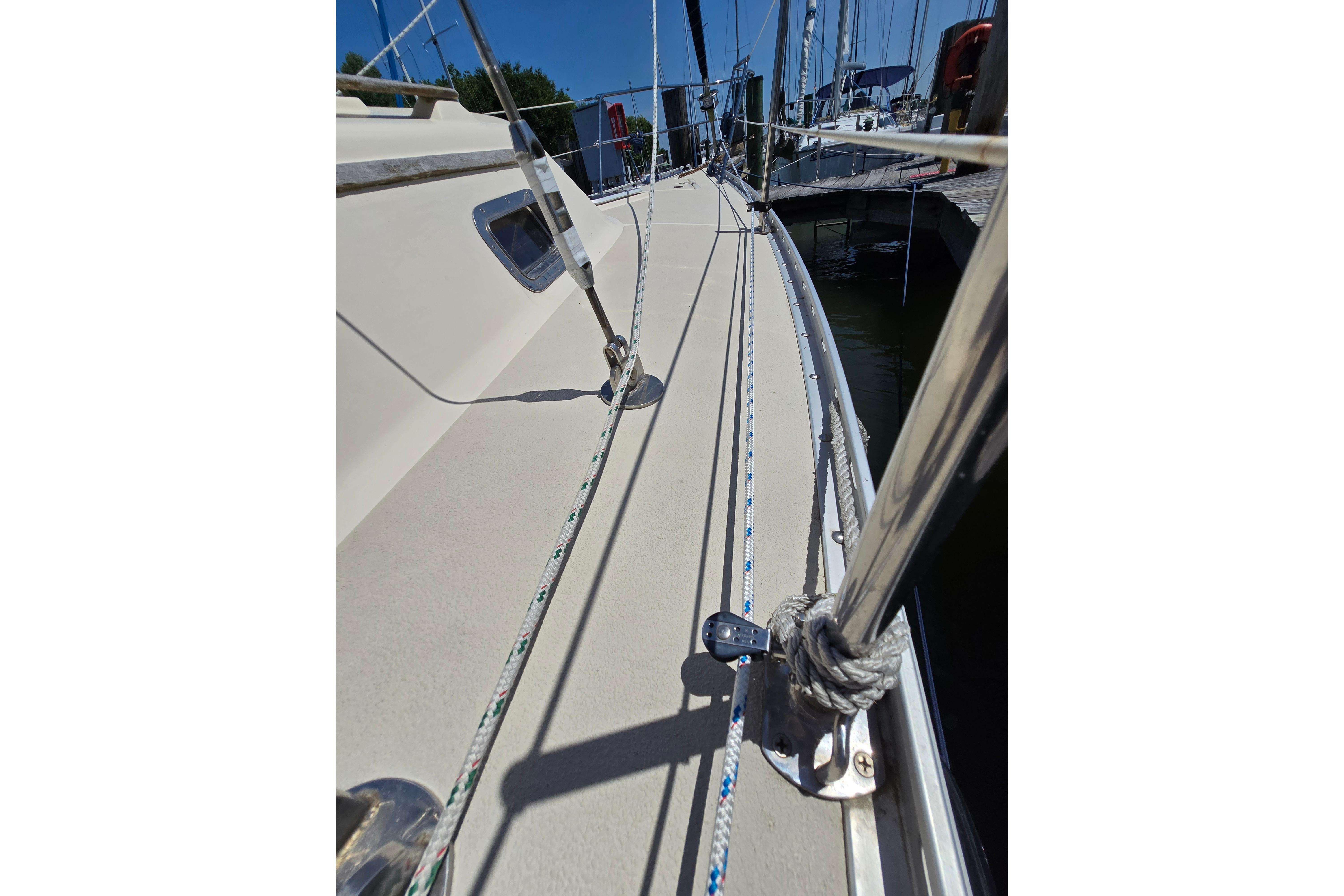 Sailboat deck view of 1993 Caliber 35, featuring rigging and docked setting.
