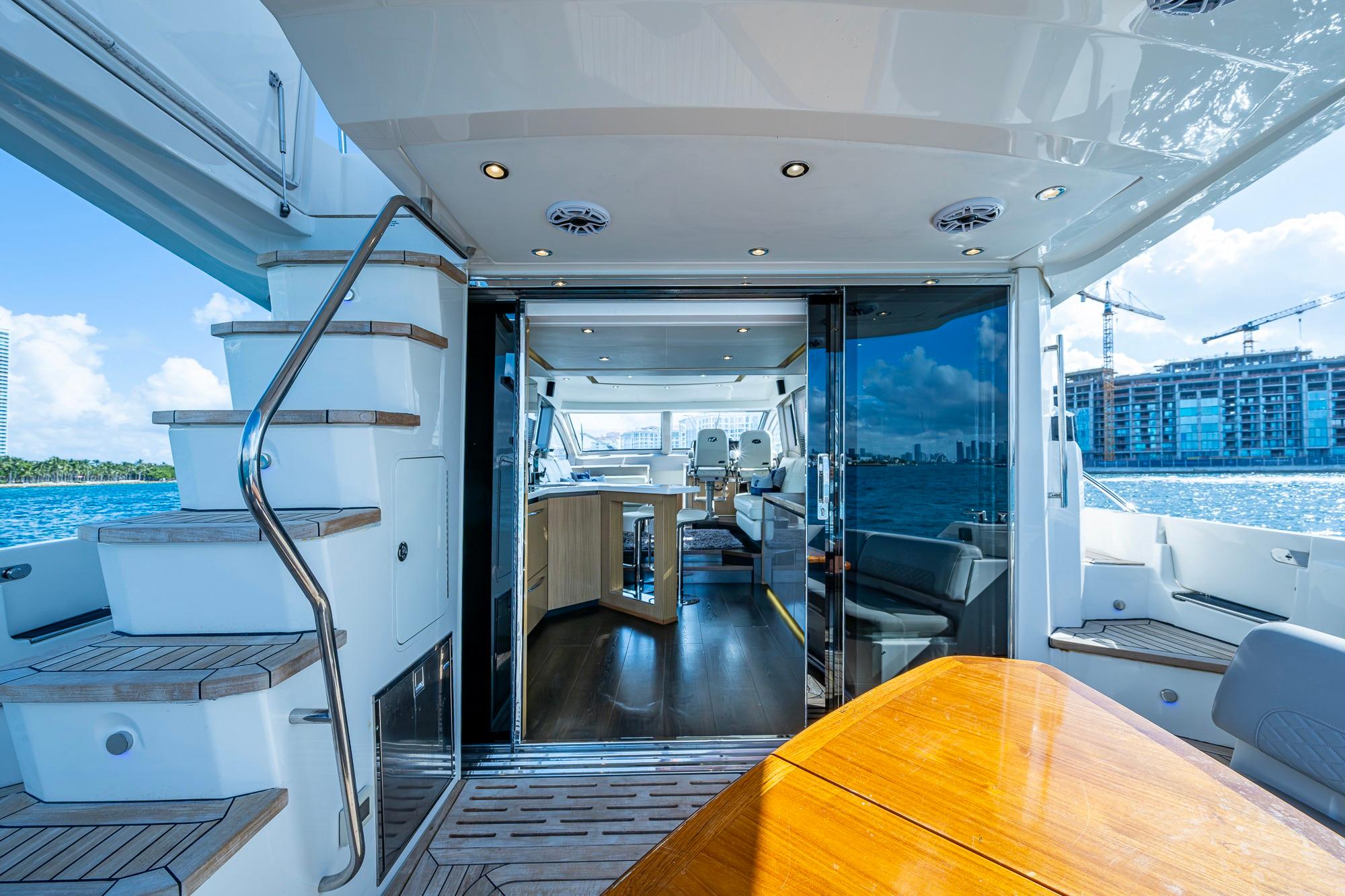 Luxurious 2018 Sea Ray L550 Fly yacht interior with elegant wood finishes and waterfront view.