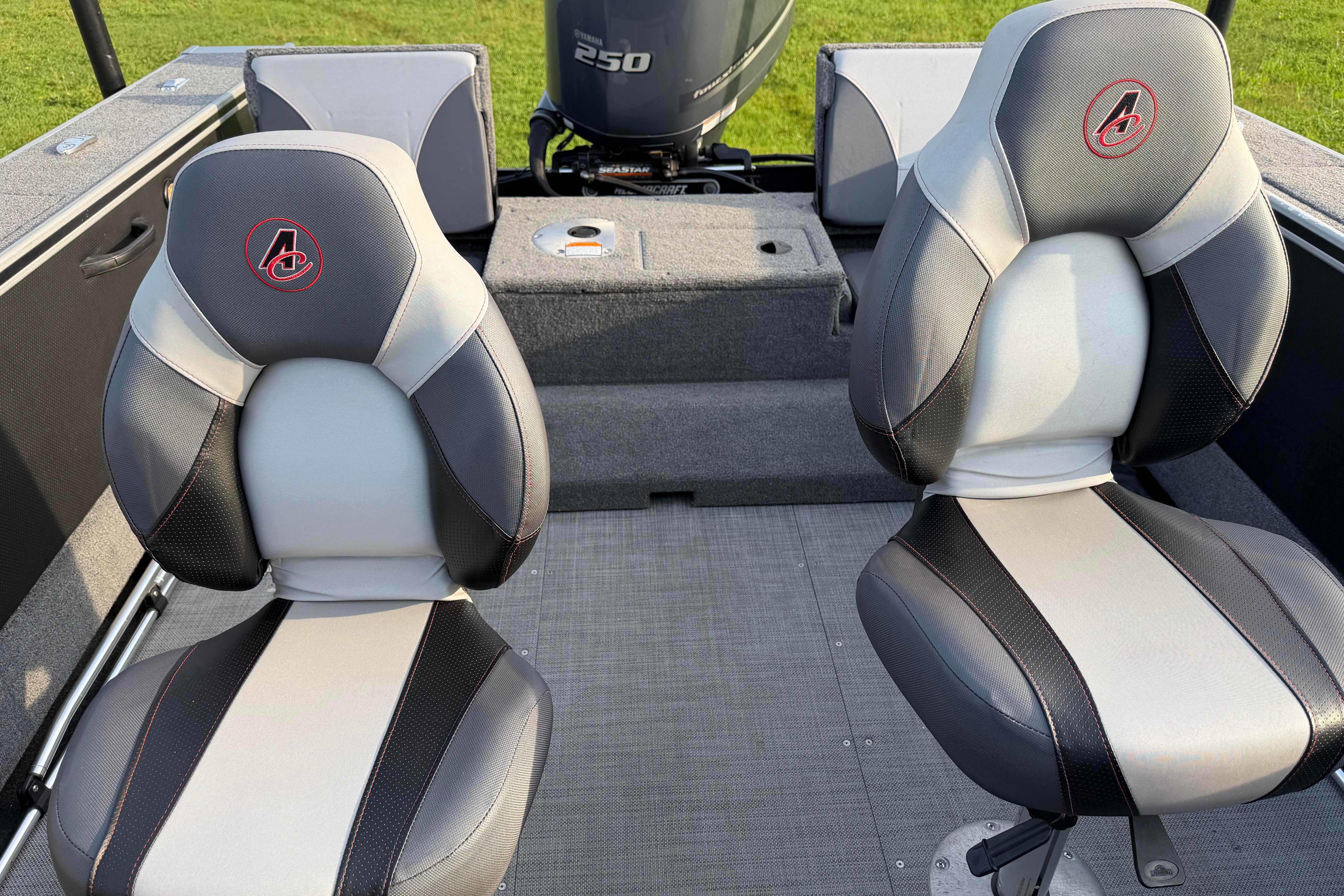 2019 Alumacraft Trophy 205 boat interior with two cushioned seats and a motor.