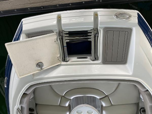 2019 Crownline E255 boat with open hatch and seating area.