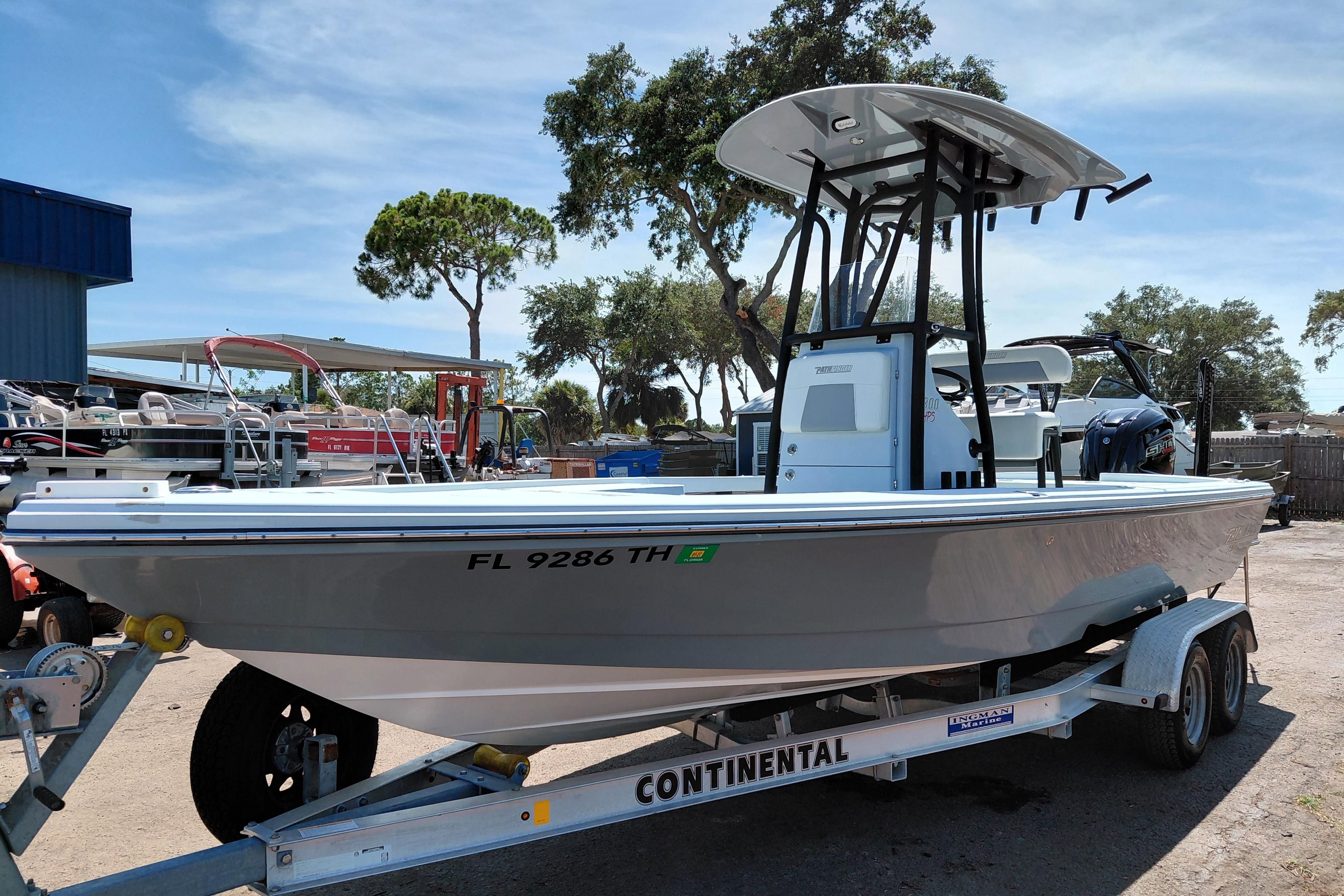 2022 Pathfinder 2300 HPS boat on trailer, parked outdoors under clear sky.