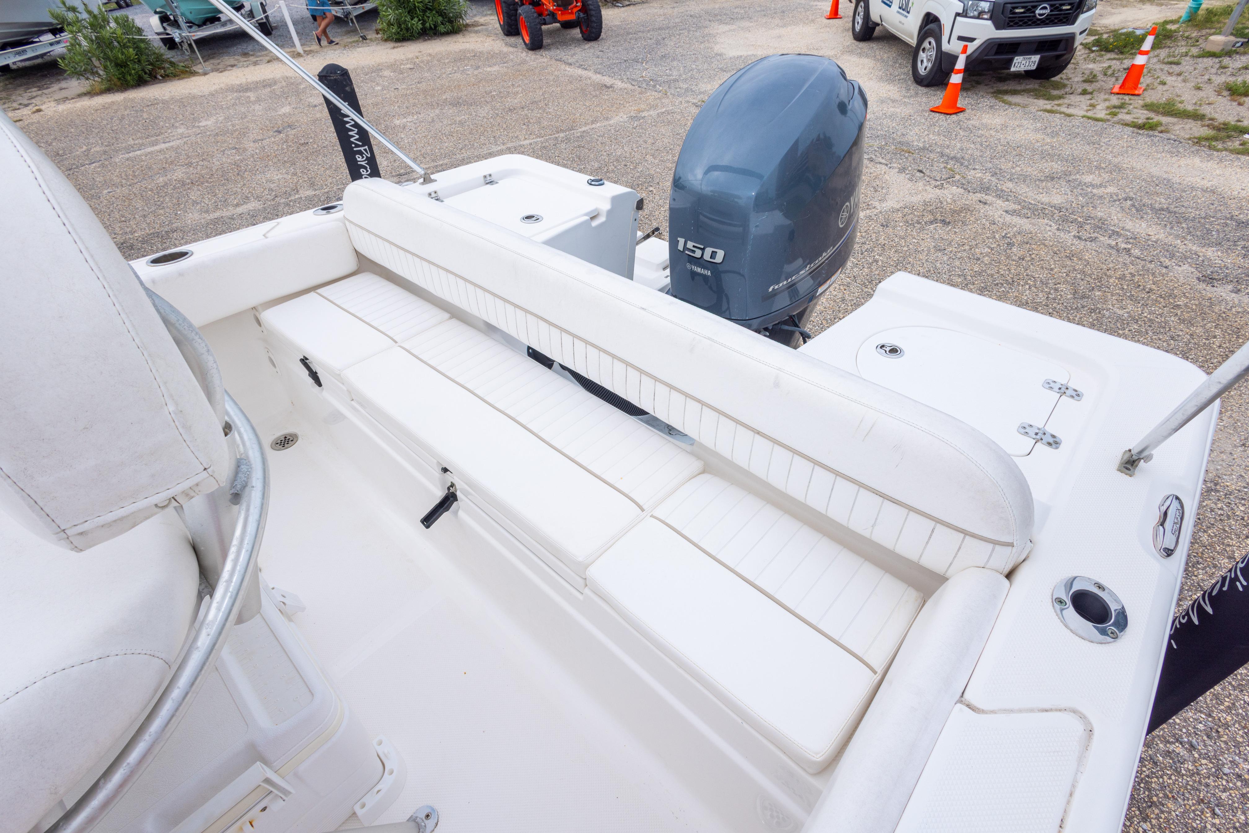 2014 Sea Fox 209 Commander boat with Yamaha 150 engine, white seating, and outdoor setting.