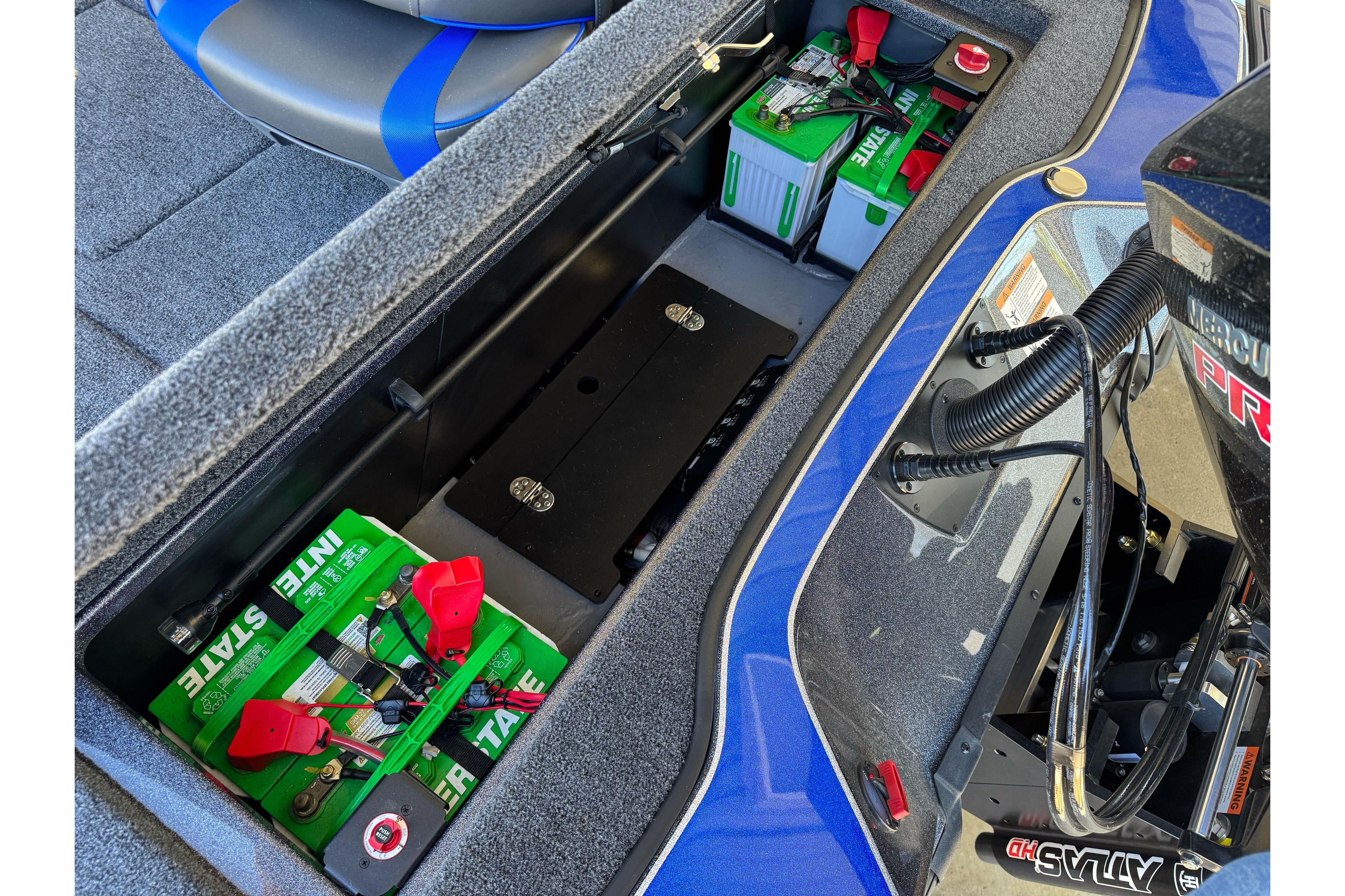 2026 Triton 21XP Patriot boat battery compartment with green Interstate batteries and wiring.