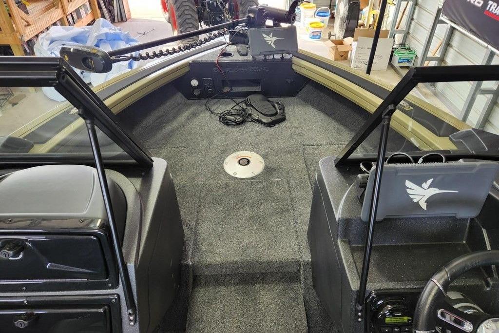 2026 Tracker Targa 185 WT boat interior with carpeted deck and storage compartments.