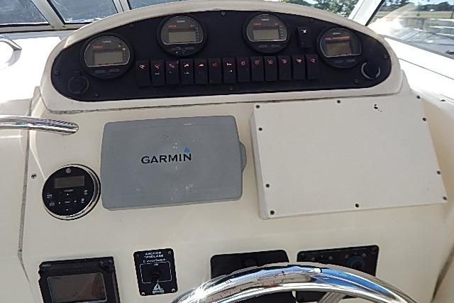 Control panel of a 2003 World Cat 270 EC boat with Garmin navigation system.