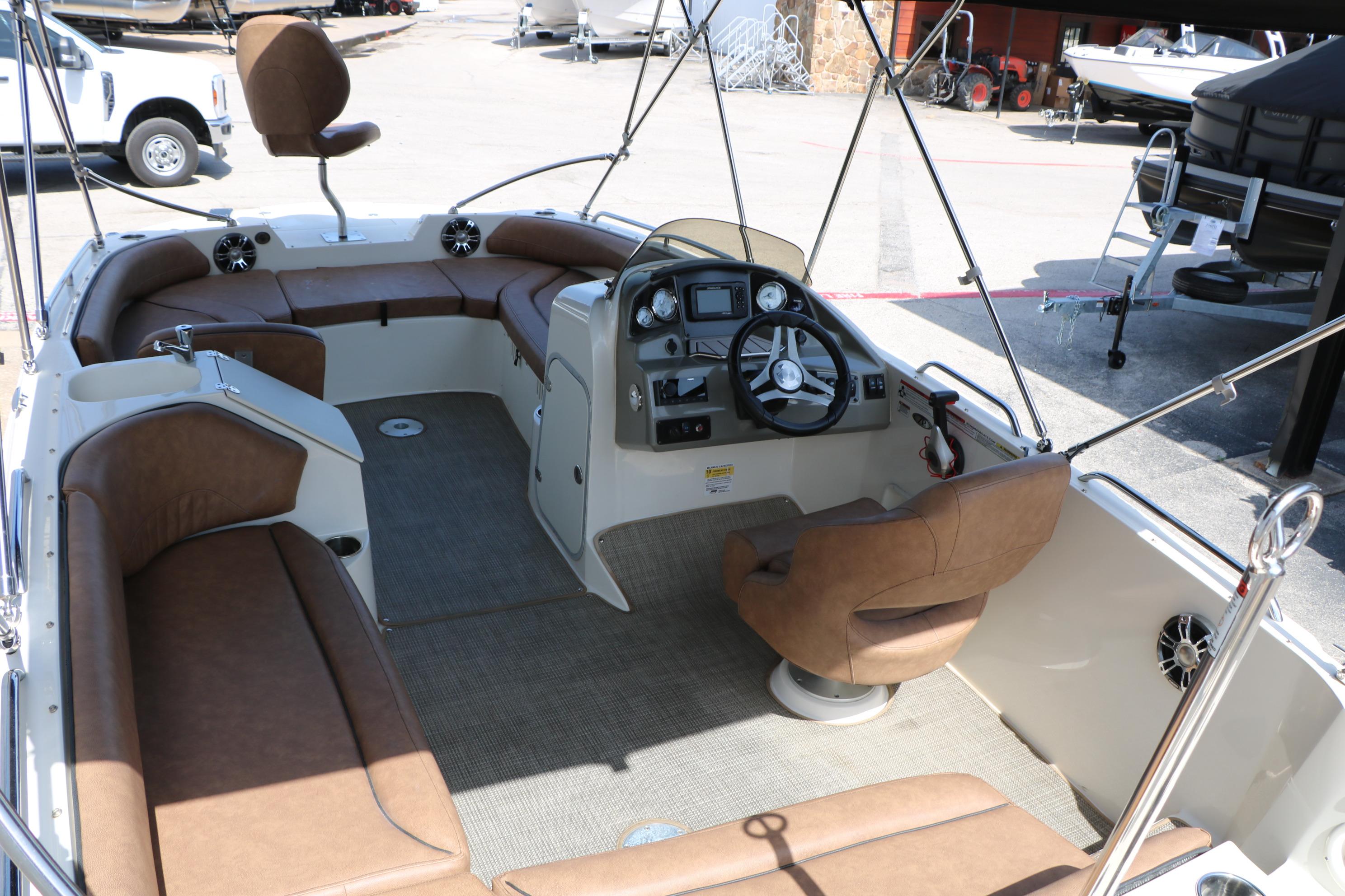 2022 Stingray 192 SC boat interior with brown seating and modern dashboard.