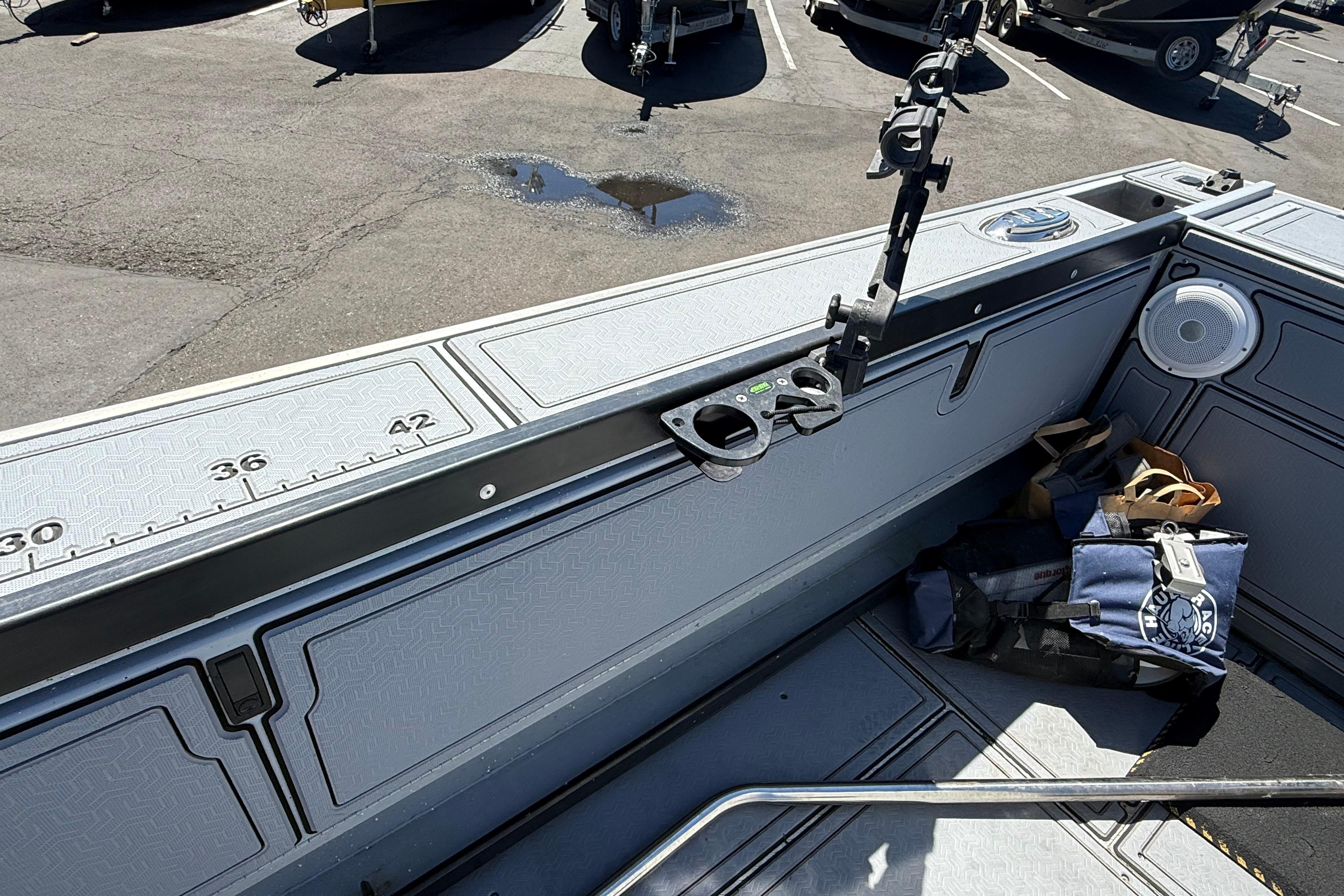 2015 Alumaweld Pacific XD 28 boat interior with rod holder and storage compartments.