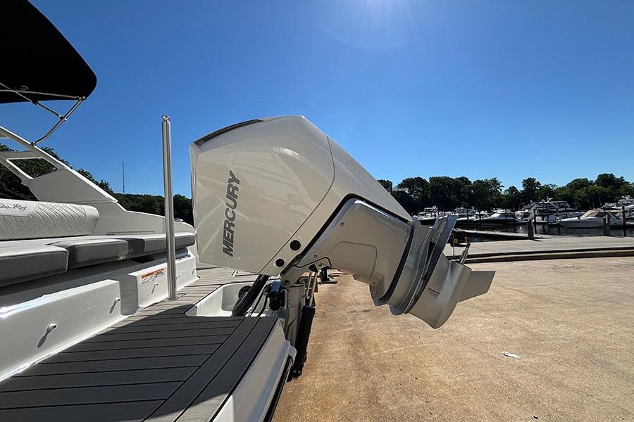 2027 Sea Ray SDX 230 Outboard with Mercury engine at marina under clear blue sky.