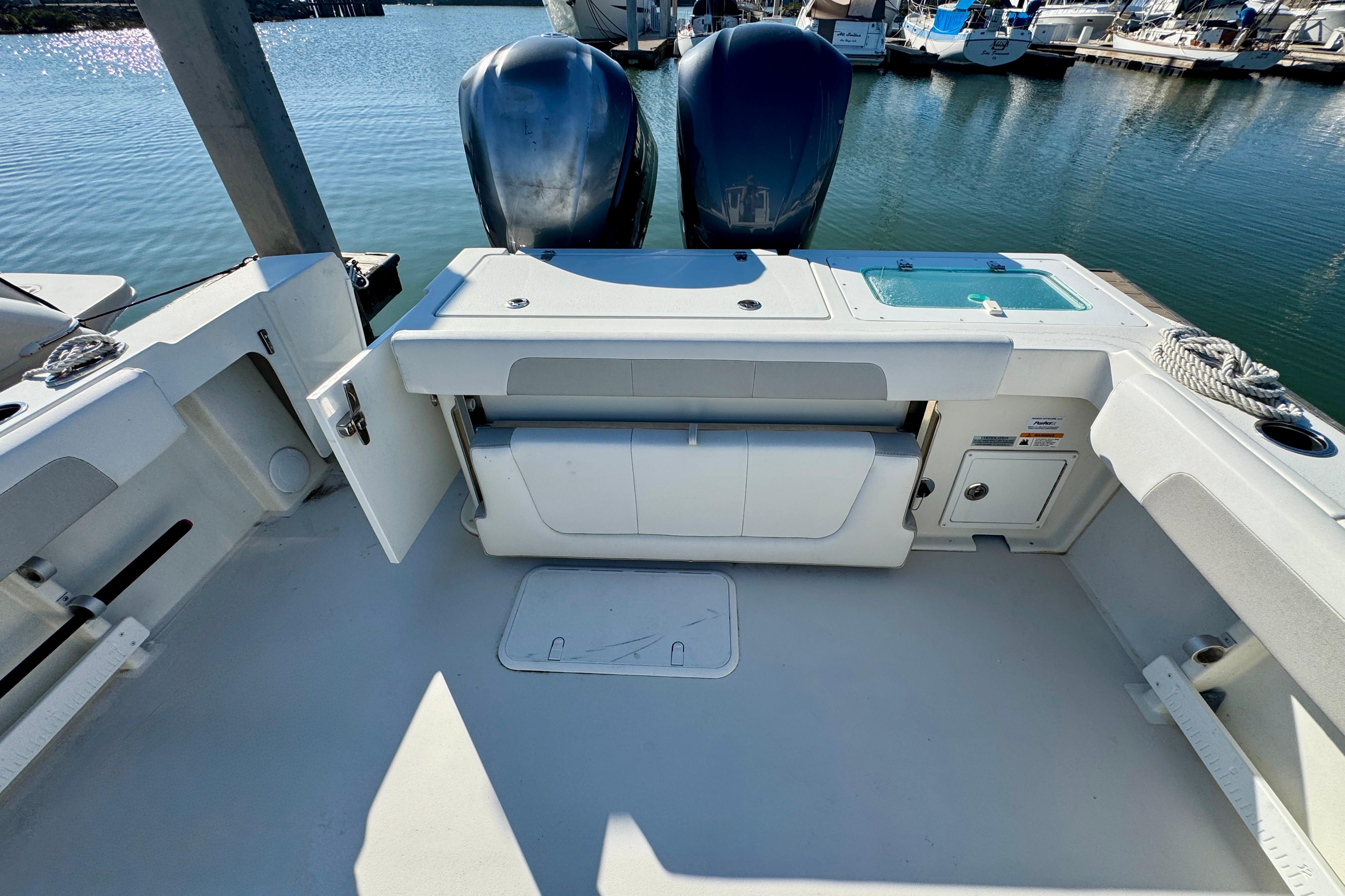 2021 Parker 2820 XLD Sport Cabin boat deck with dual engines at marina.