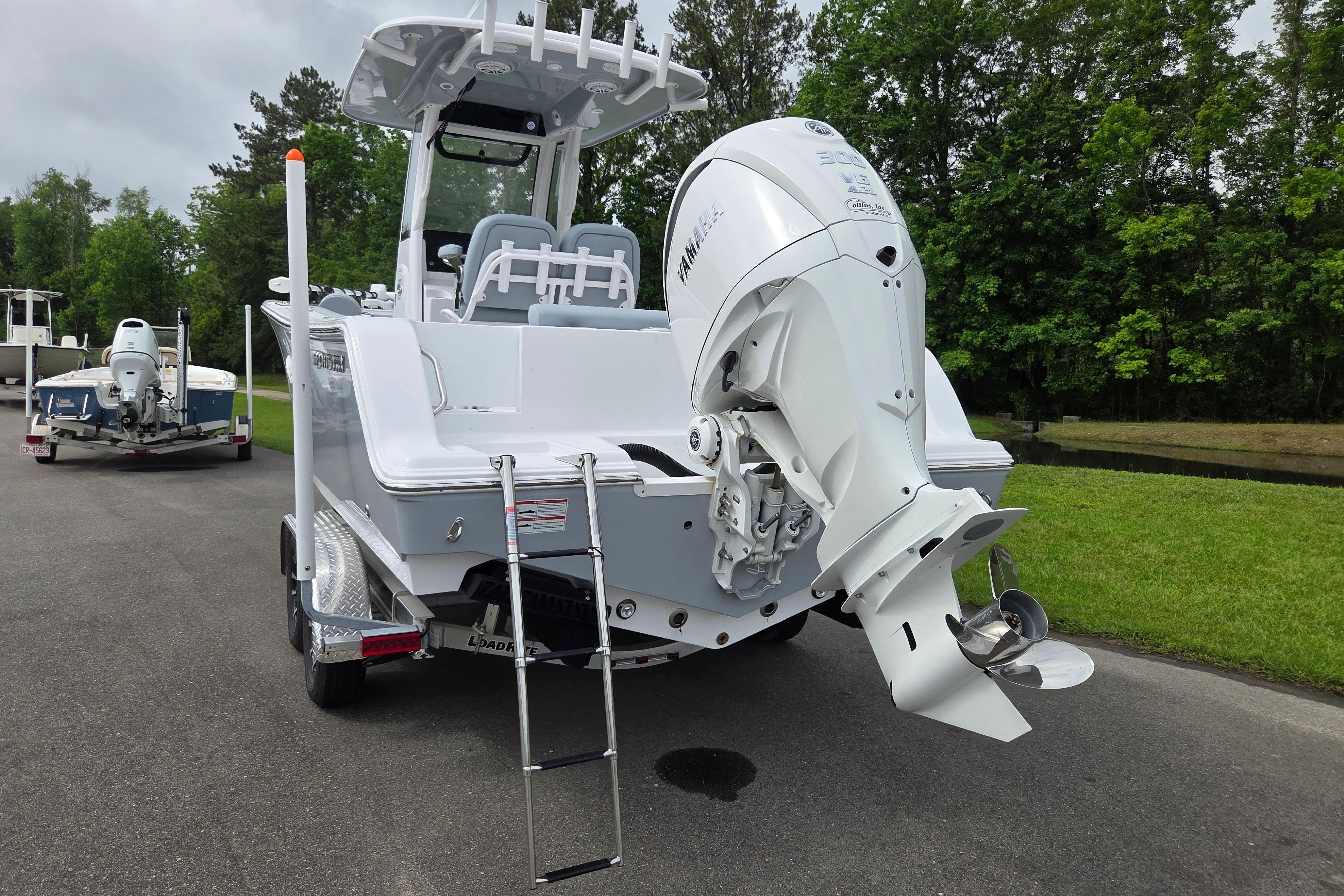 2026 Sportsman Open 232 Center Console boat with Yamaha outboard motor on trailer.