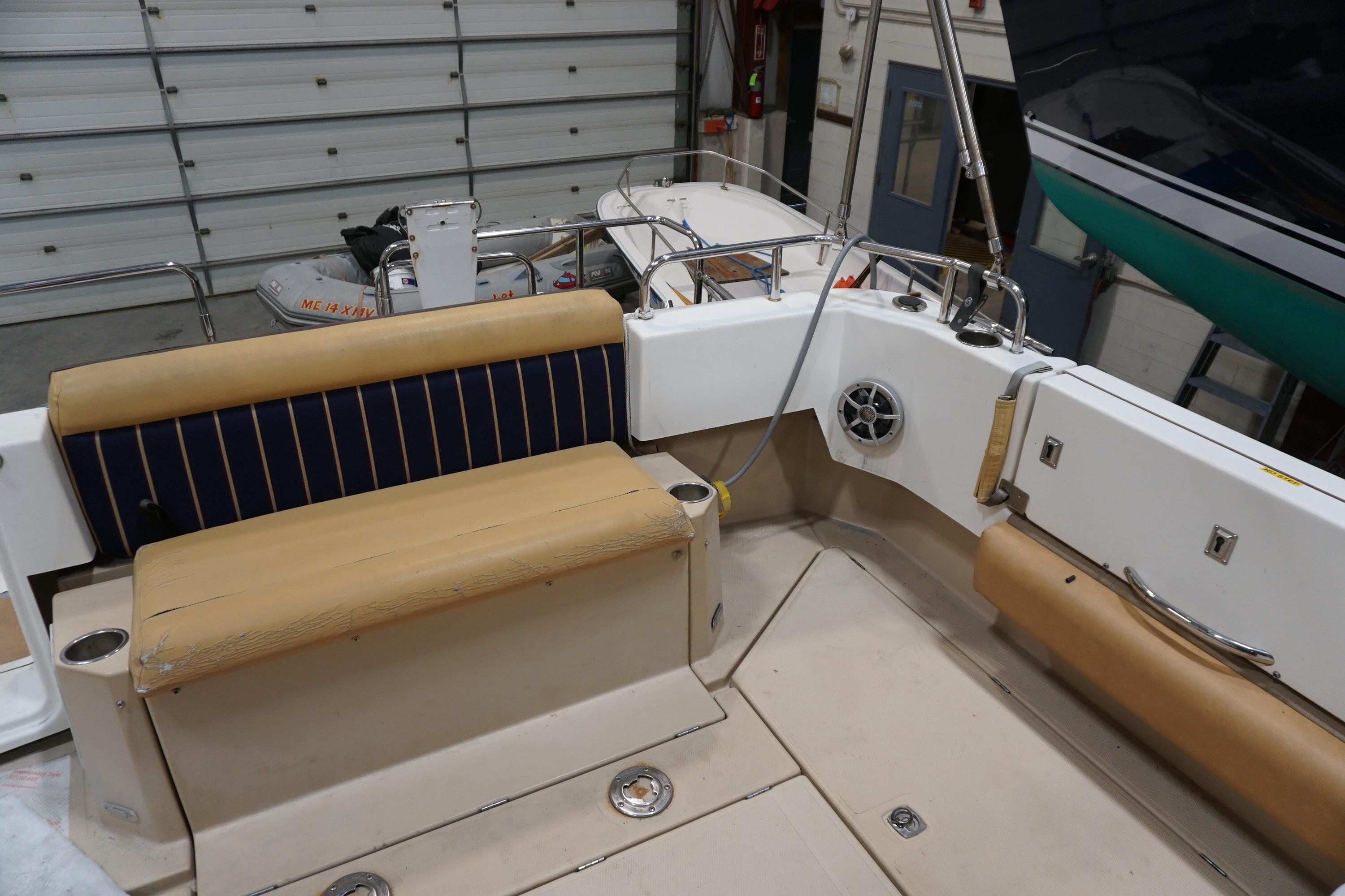 2013 Ranger Tugs S-31 boat interior with seating and storage in a garage.