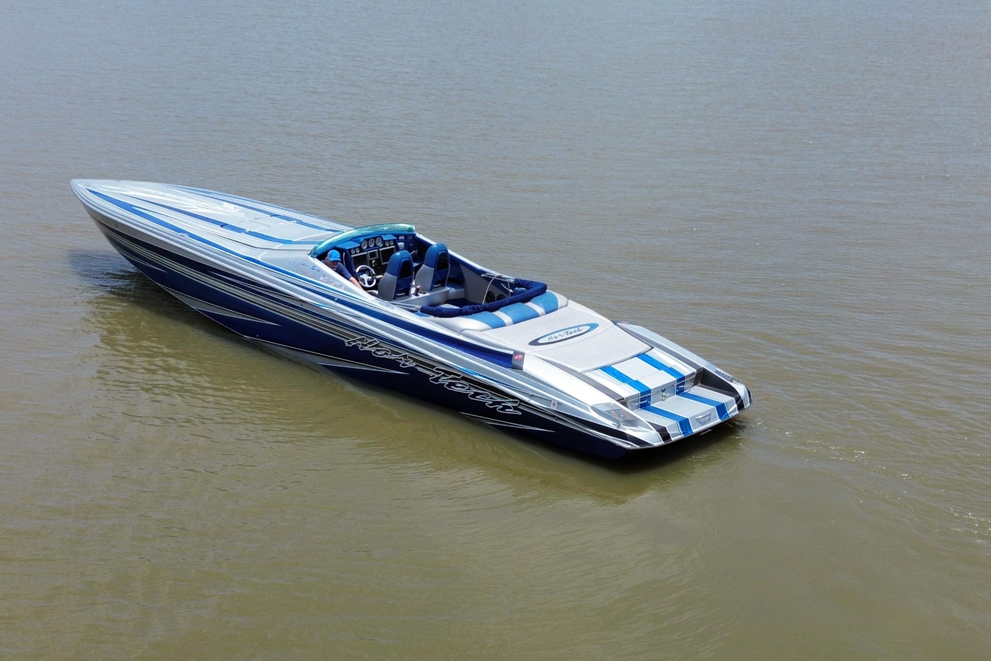 2013 Nor-Tech 477 SPX Vee Bottom boat on calm water, featuring sleek blue and white design.