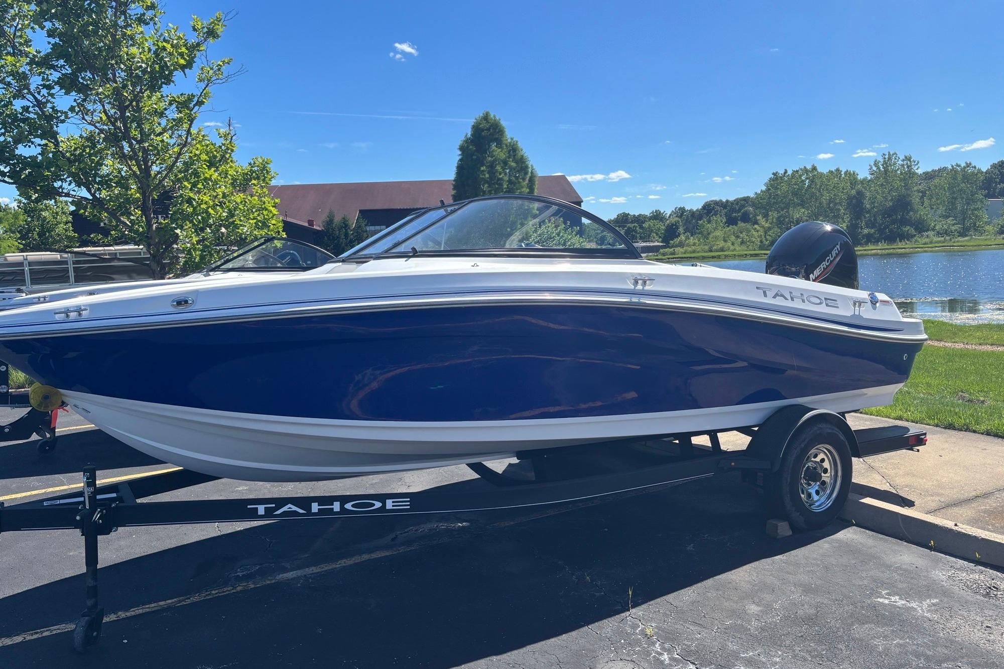 2024 Tahoe 200 S boat on trailer by a lake under clear blue sky.